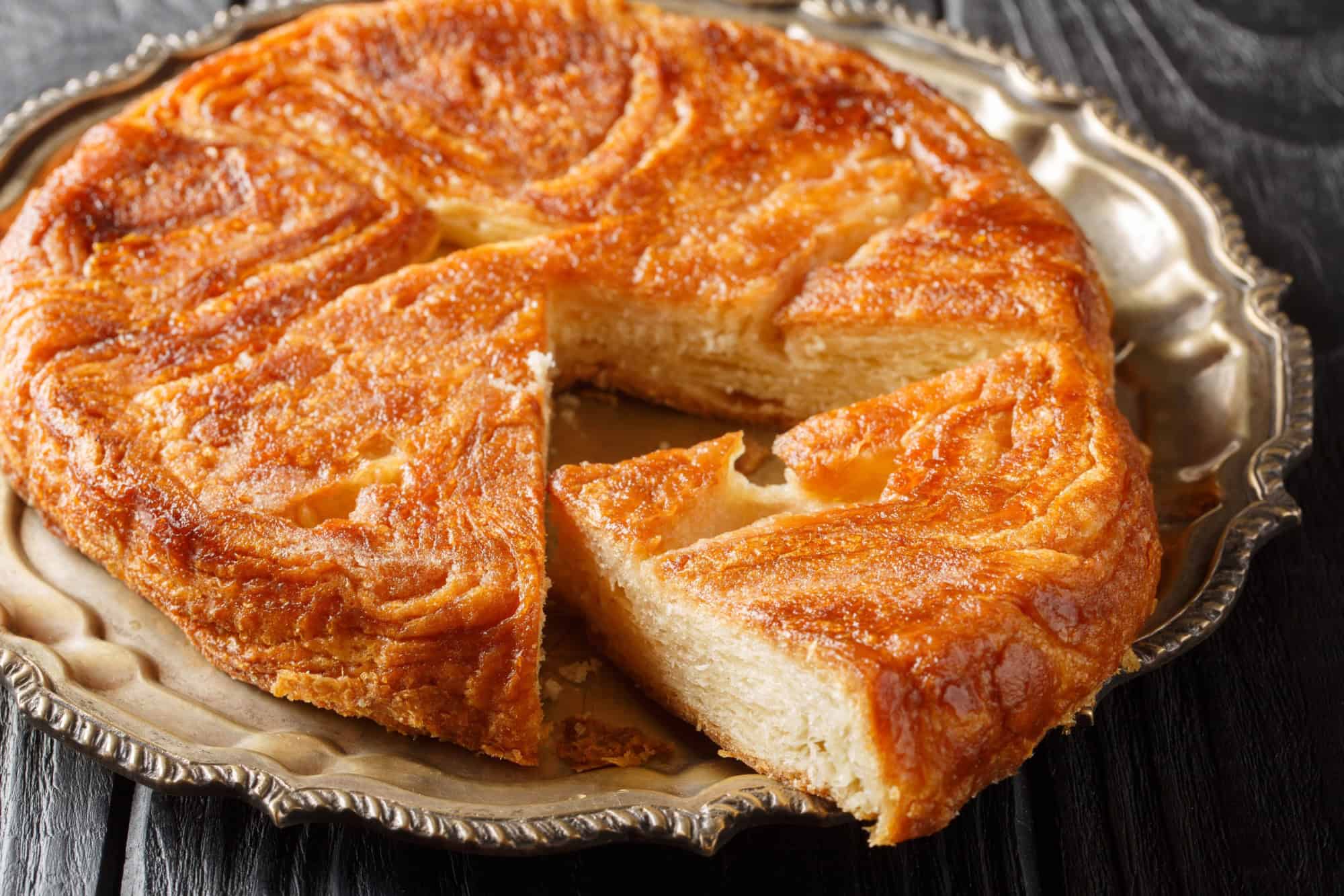 Kouign amann traditional french sweet cake closeup on the plate on the table. Horizontal