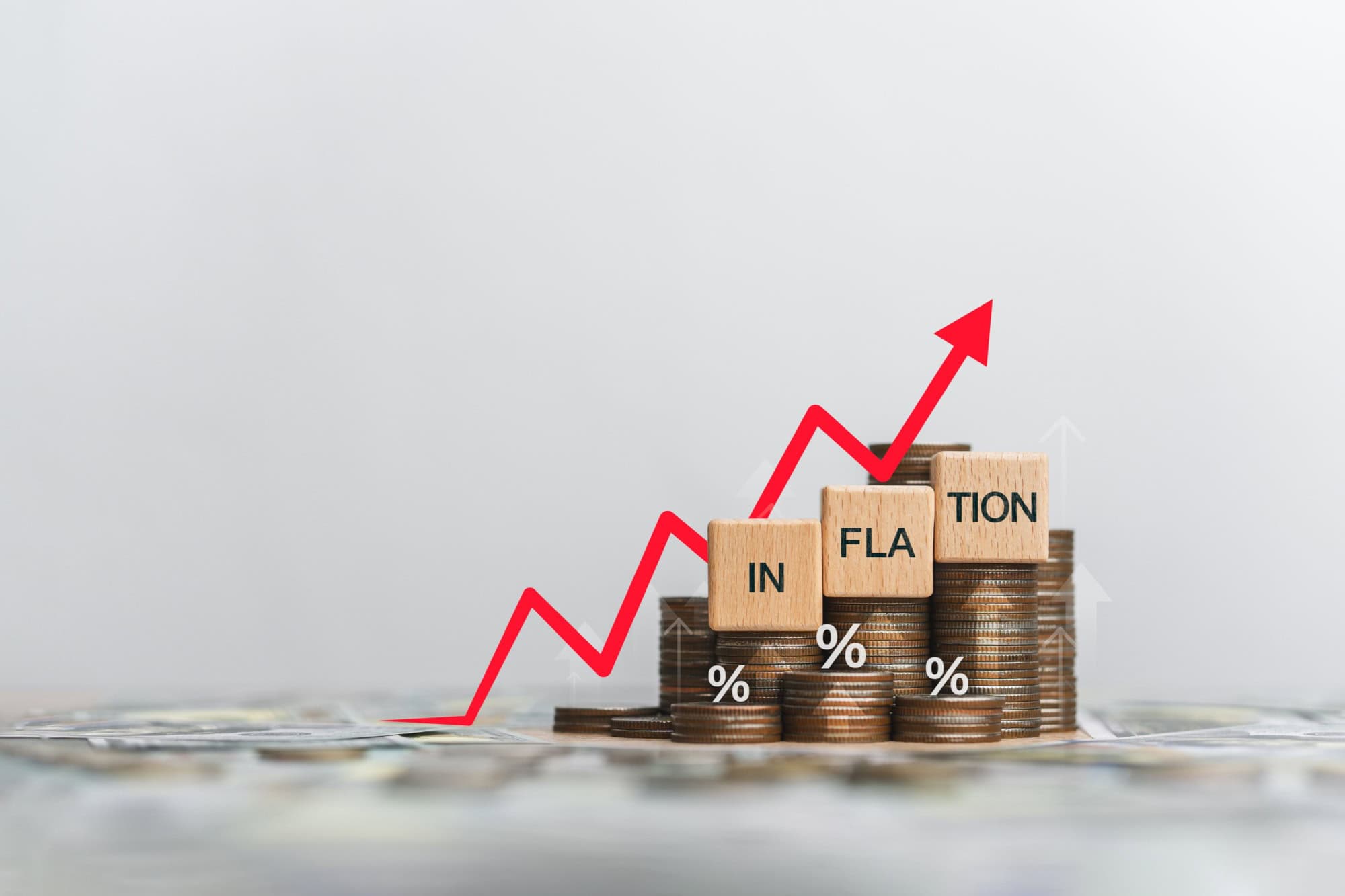 Wooden block and the word inflation on a coin placed. Inflation concept for the FED. Considering raising interest rates. Global economy, bankruptcy and controlling inflation. US dollar inflation.