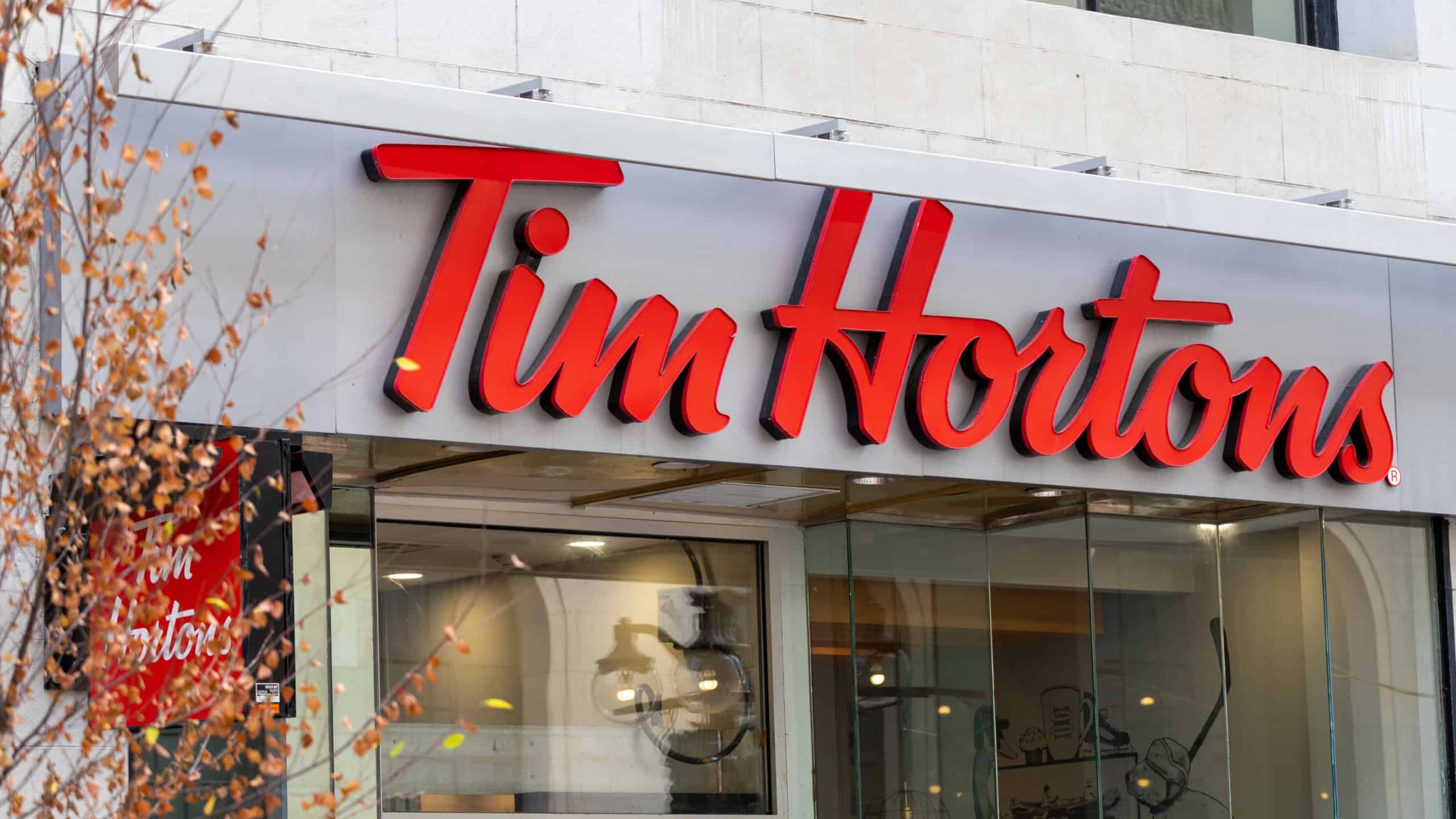 Ottawa, Canada - November 10, 2022: Signage of Tim Hortons fast food restaurant in downtown of the city in autumn.