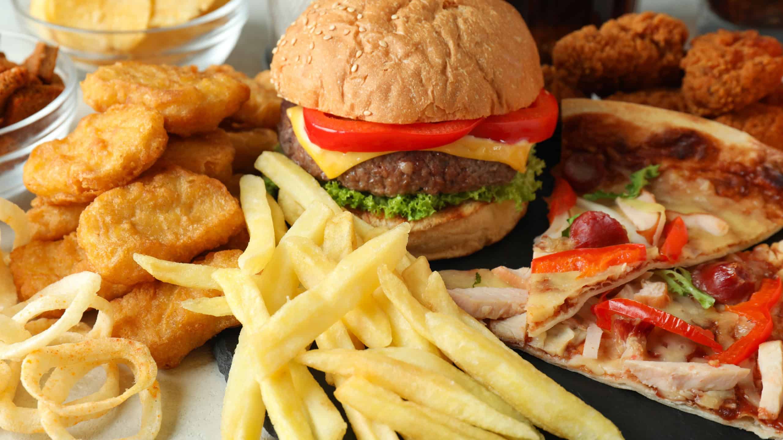 Concept of fast food on white textured table