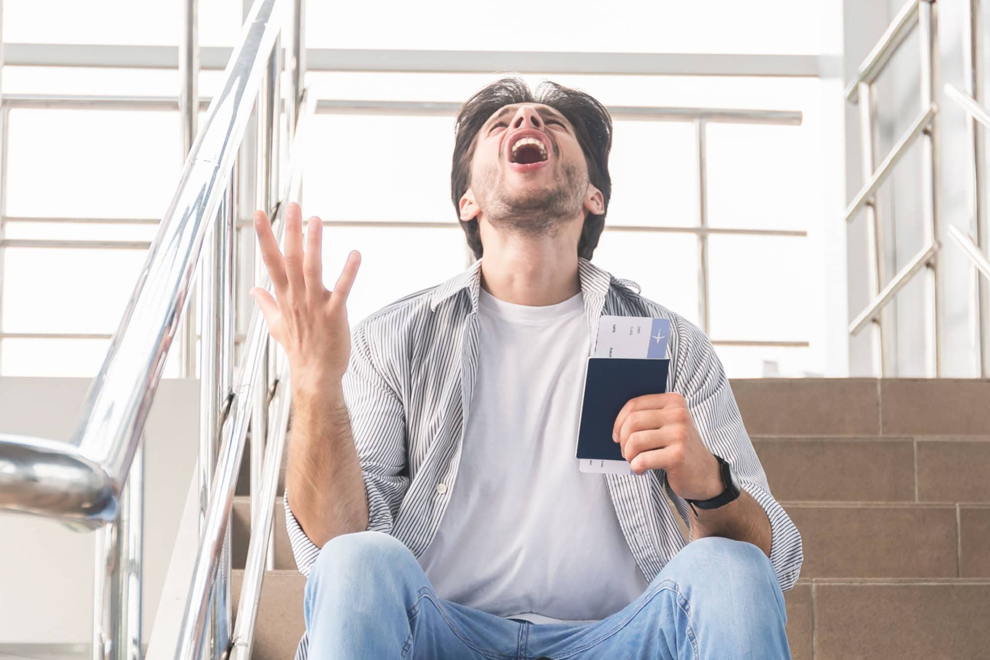 Lost Flight. Desperate Man Sitting In Airport With Passport, Border Closed Due To Coronavirus, Guy Emotionally Yelling Why, Panorama With Free Space