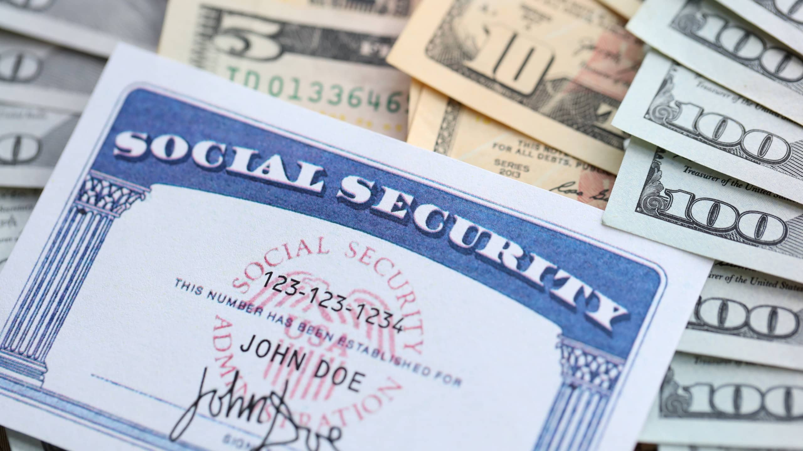 American US dollars money bills and US social security number card close up