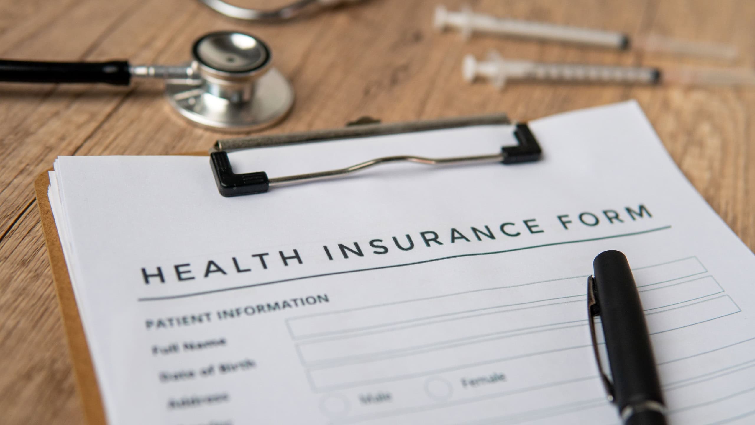 A close-up image of health insurance form on a clipboard. Medical and insurance concept.