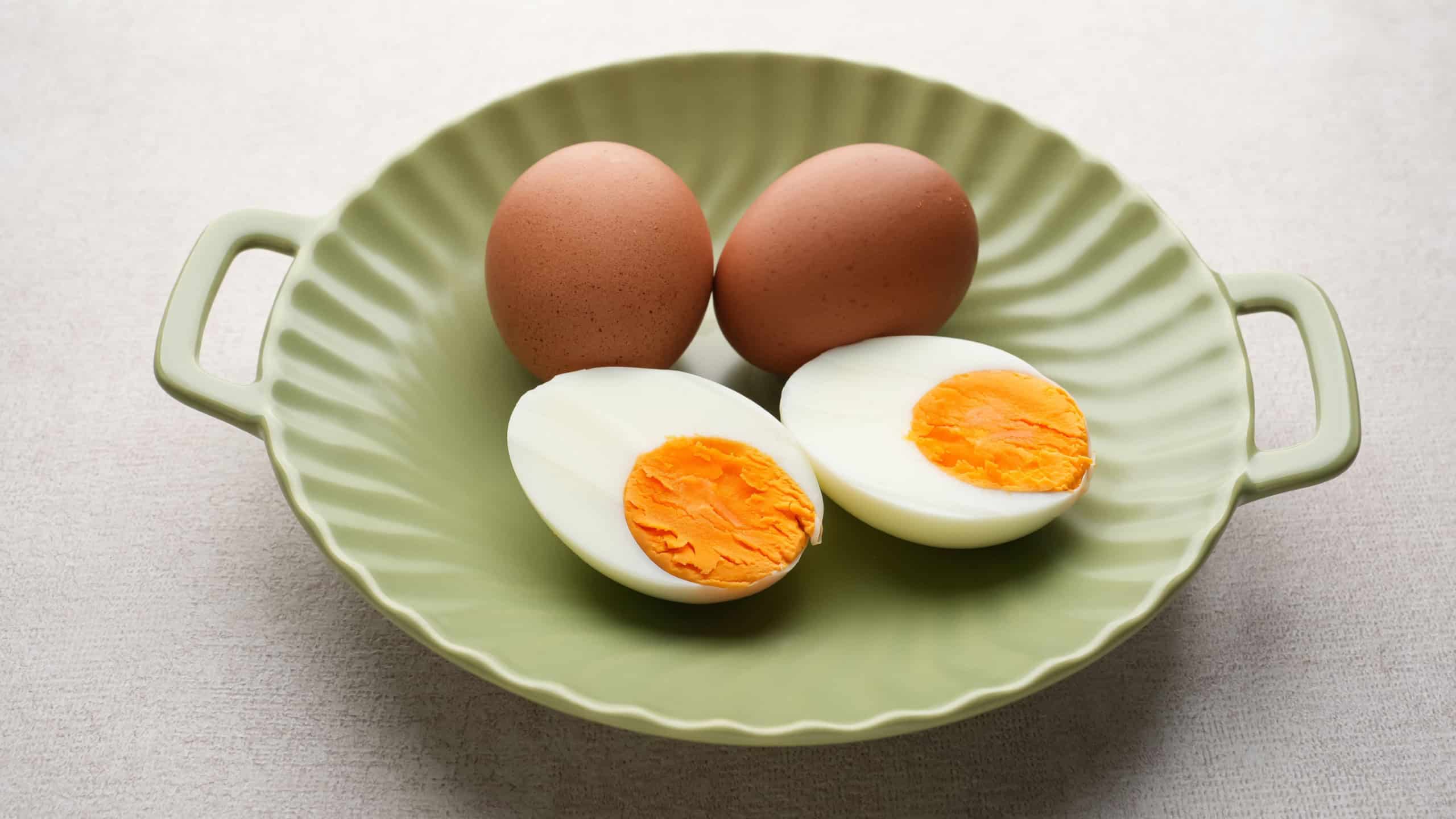 Hard boiled eggs peeled and cut in plate