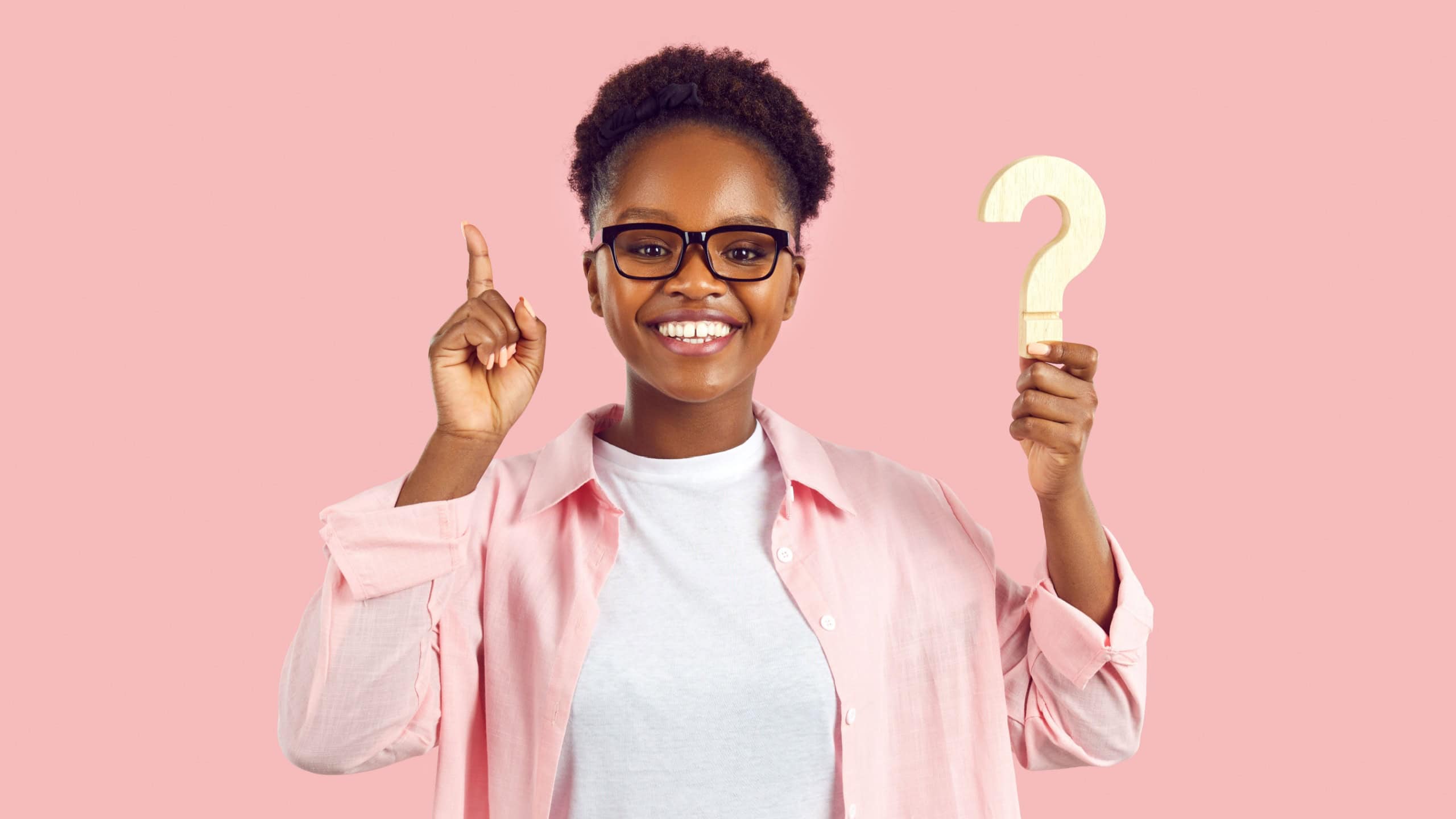 Smart clever intelligent casual young adult lady with question mark finds inspiration, has good idea, knows answer, smiles, points up, solves test puzzle quiz, shares important women's health advice