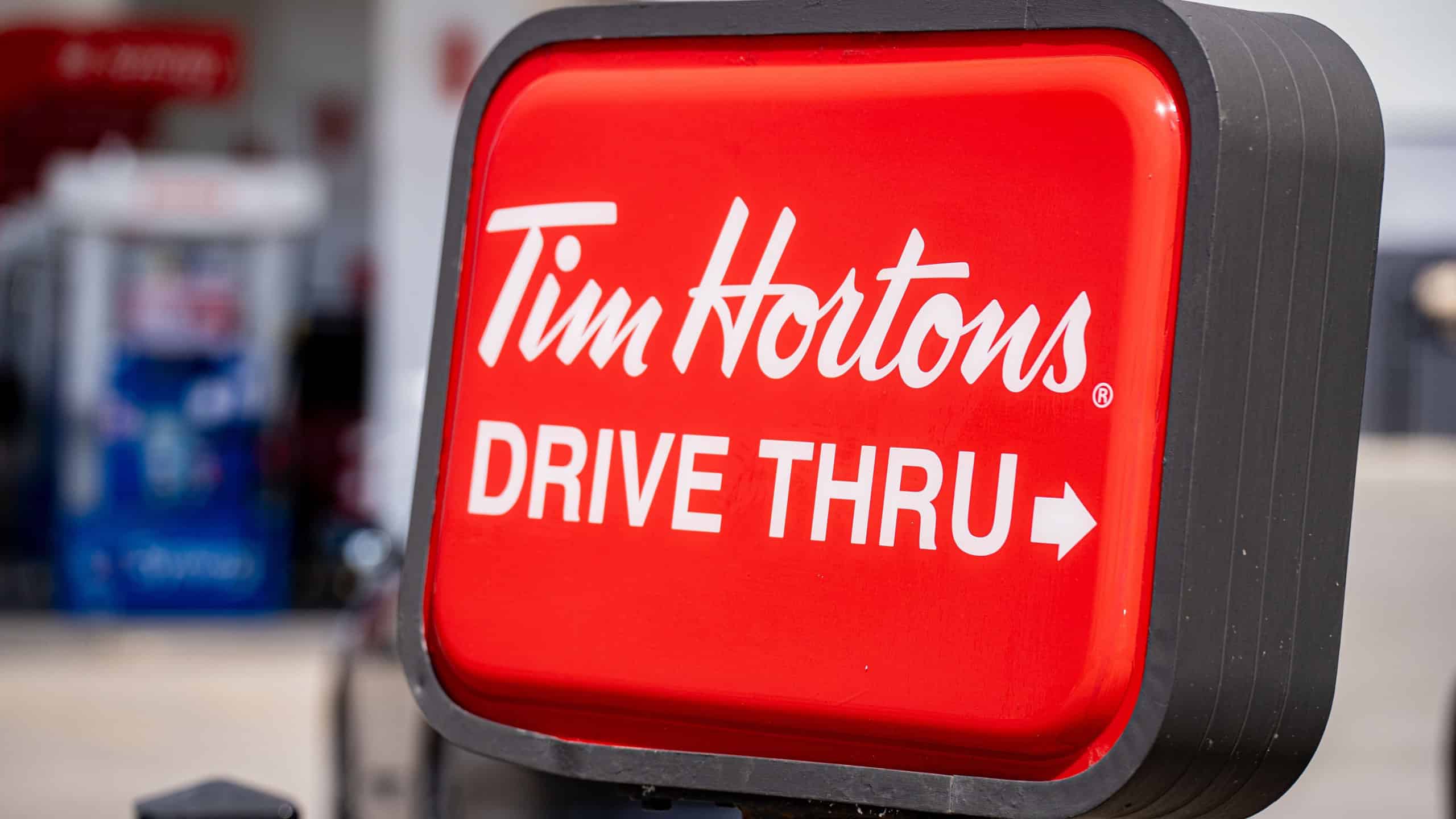 View of Tim Hortons drive thru sign at coffee shop exterior. Toronto, Canada - April 23, 2026.