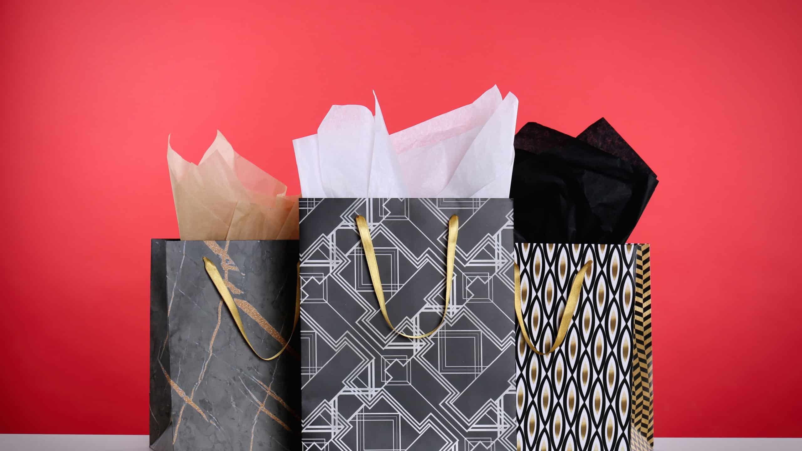 Shopping bags with paper on red background