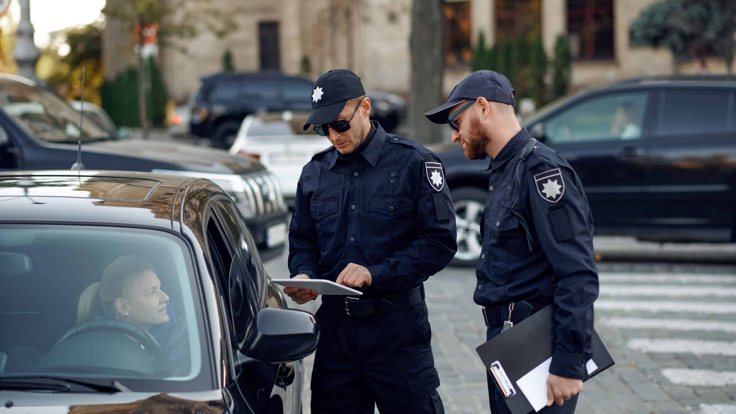 Male police officers checking the driver's license