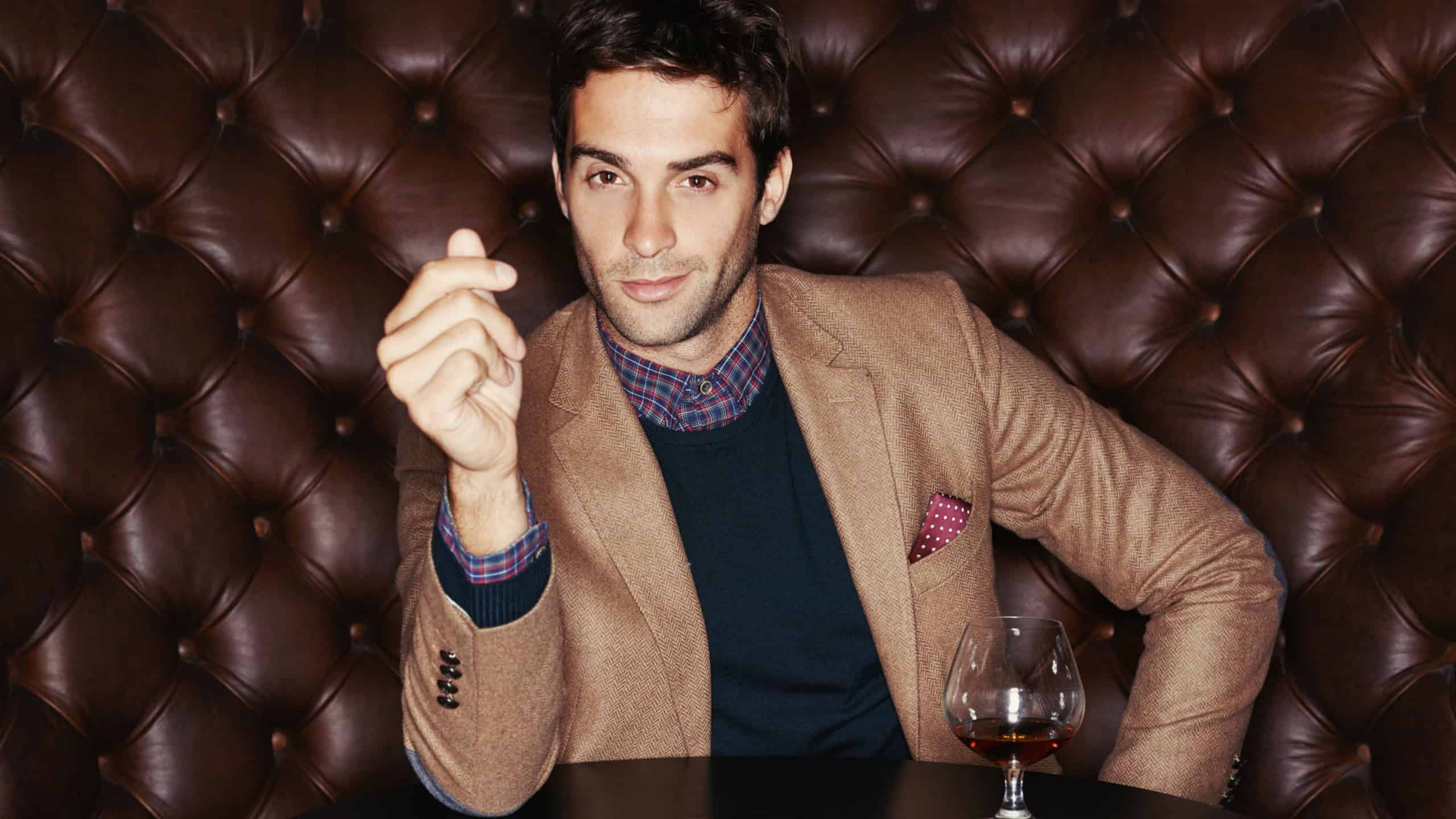 Enjoying the finer things. Portrait of a handsome young man drinking in a club.