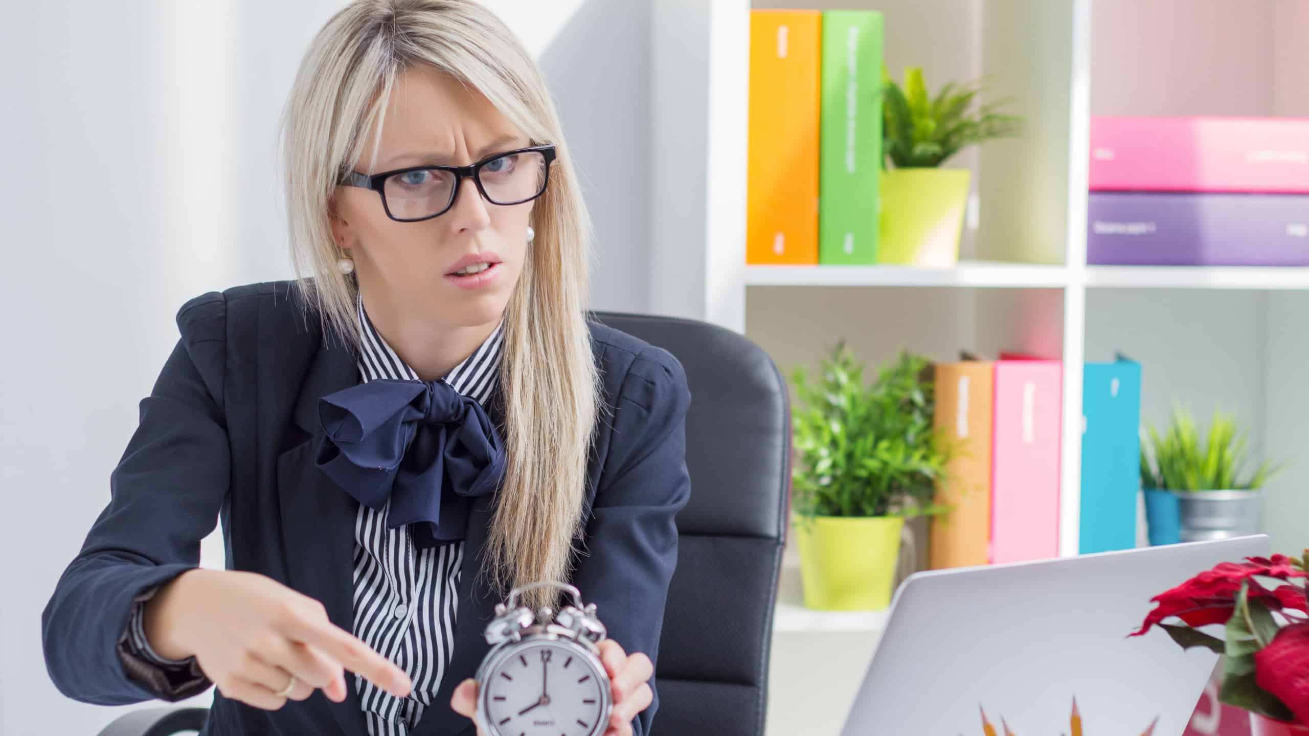 Frustrated business woman is angry about being late at work