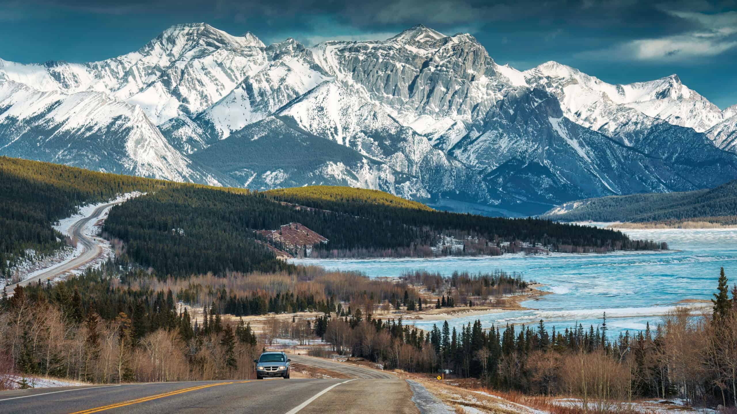 Beautiful scenery of Road trip on highway with rocky mountains and frozen lake at Icefields Parkway, Alberta, Canada