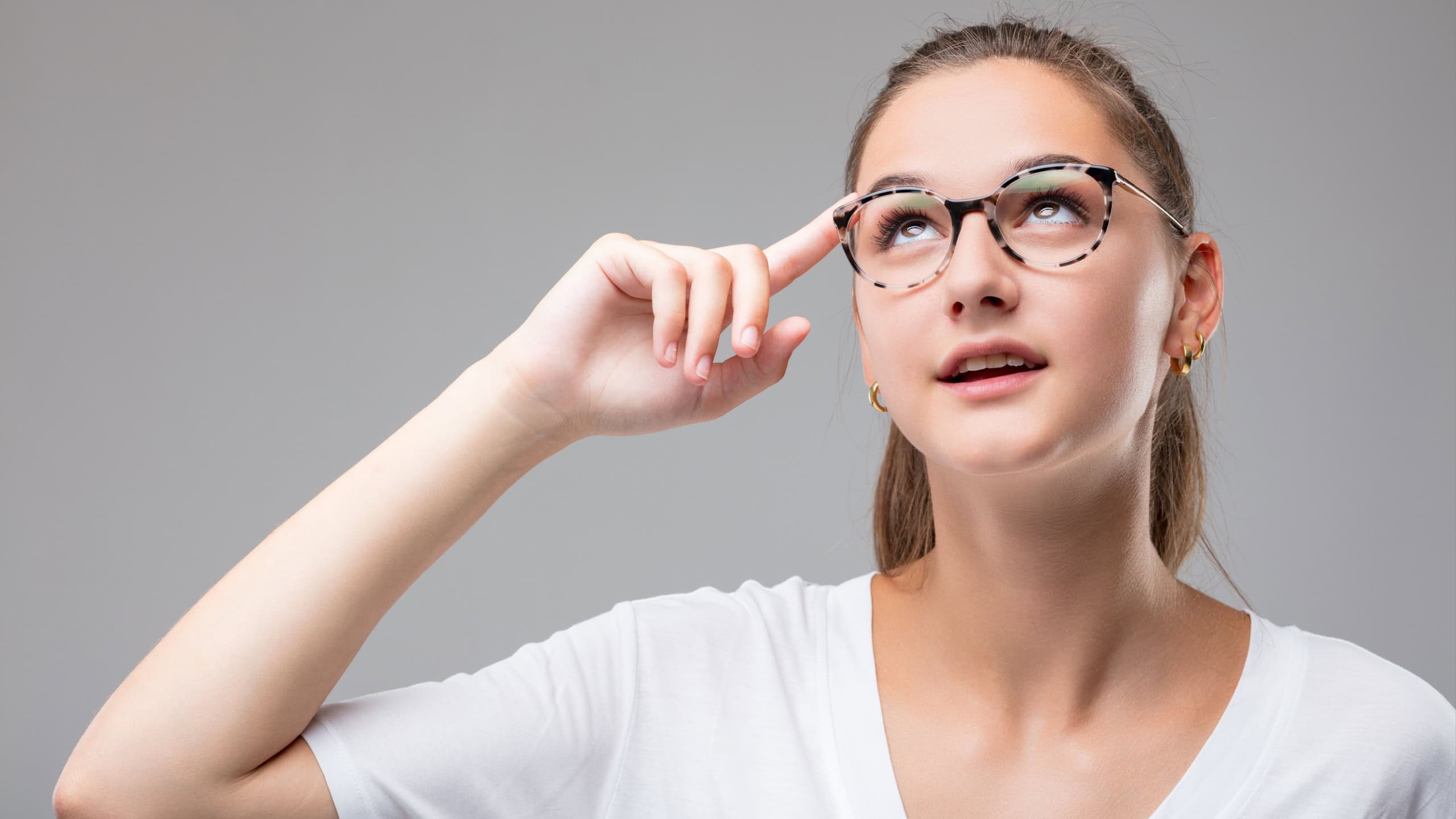 An intelligent, ingenious woman's face signals that she's made an intuitive leap, connecting thoughts and devising a solution