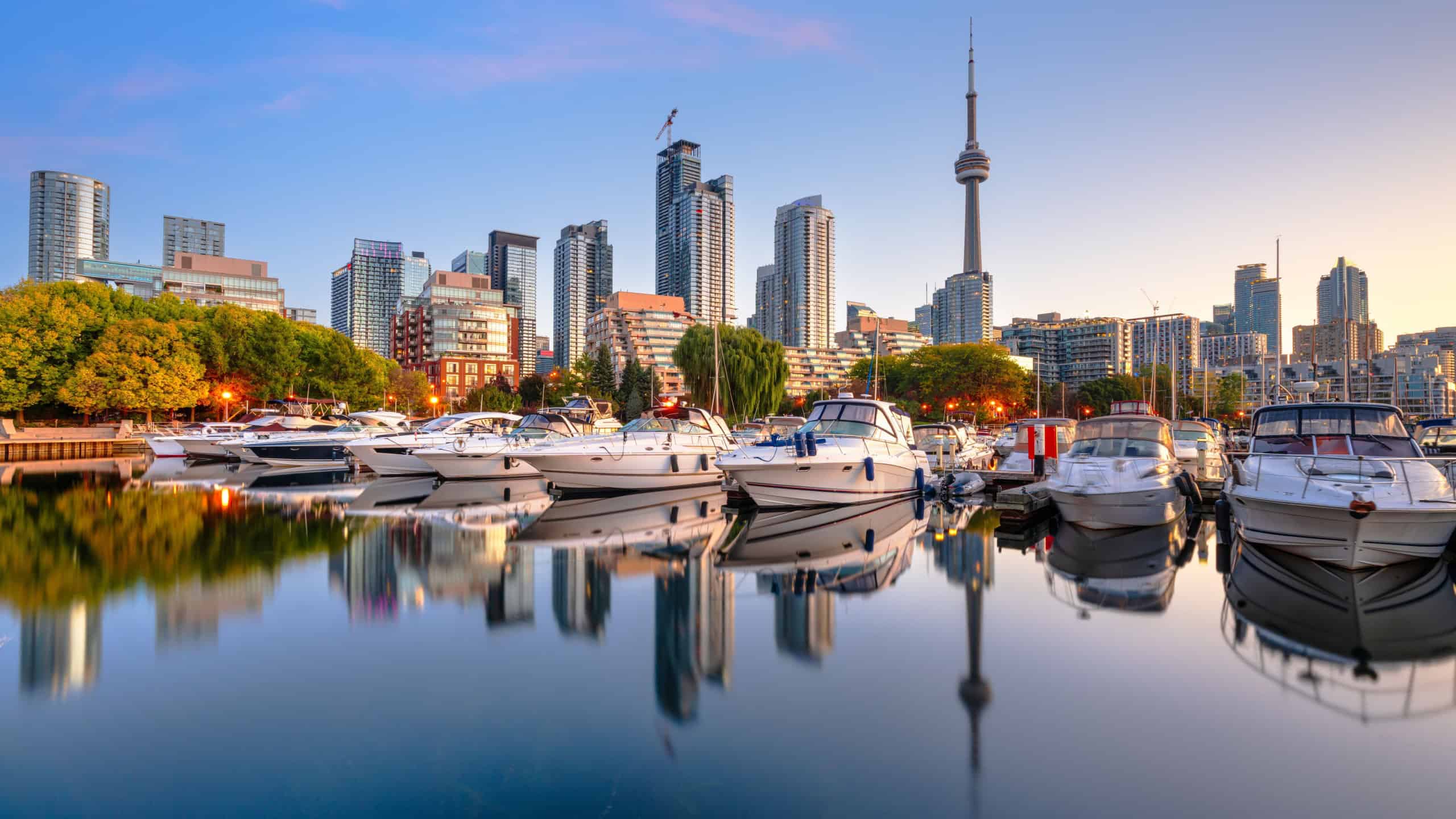Toronto, Canada city skyline with Harbourfront at dawn on Lake Ontario.