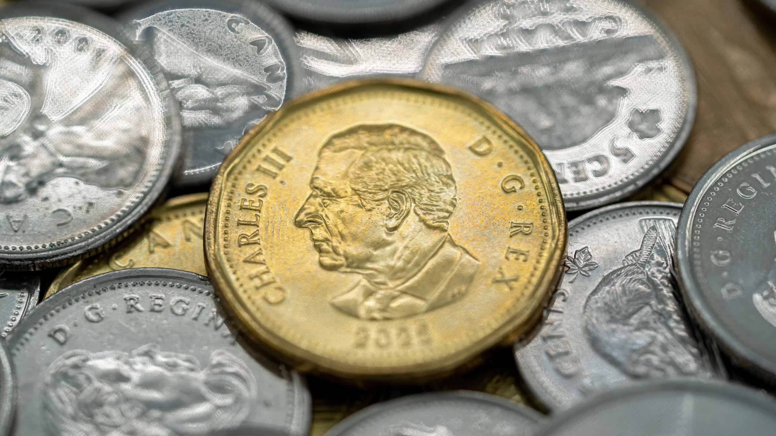 Close up of Canadian coins with King Charles III portrait on one dollar. Toronto, Canada - September 18, 2025.