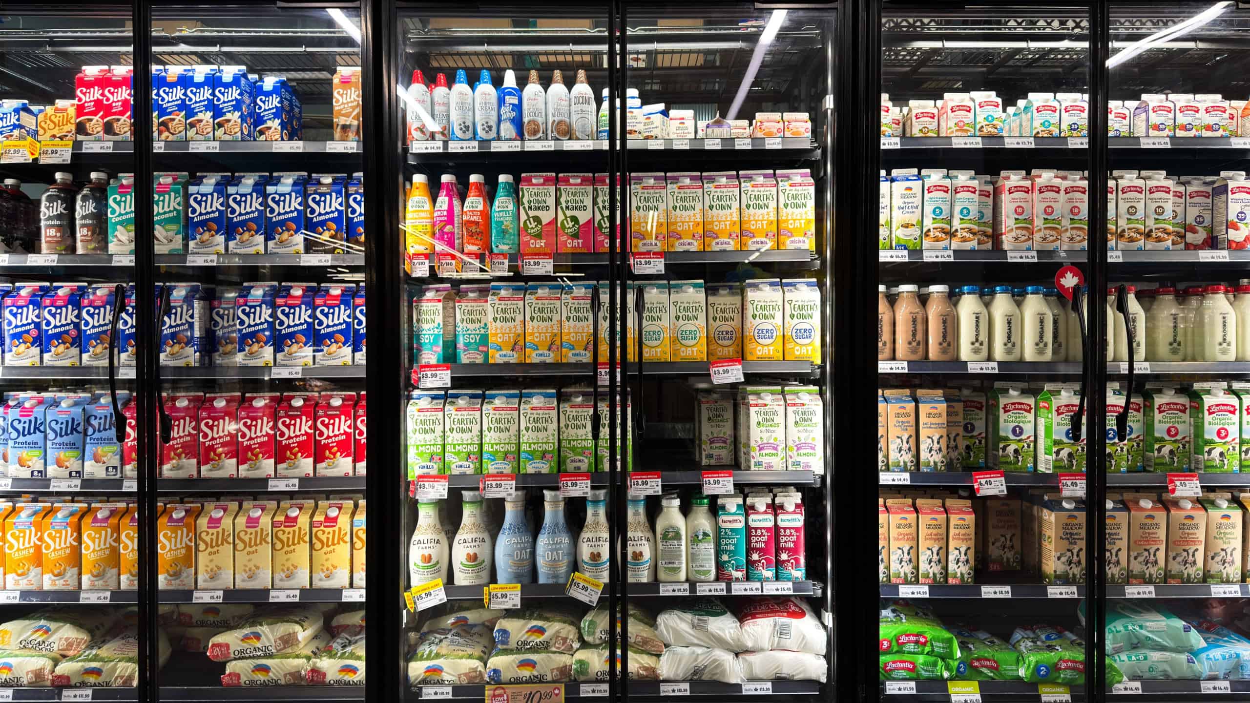 Toronto, Canada - May 01, 2026: Neatly arranged refrigerated dairy products with visible prices for retail presentation