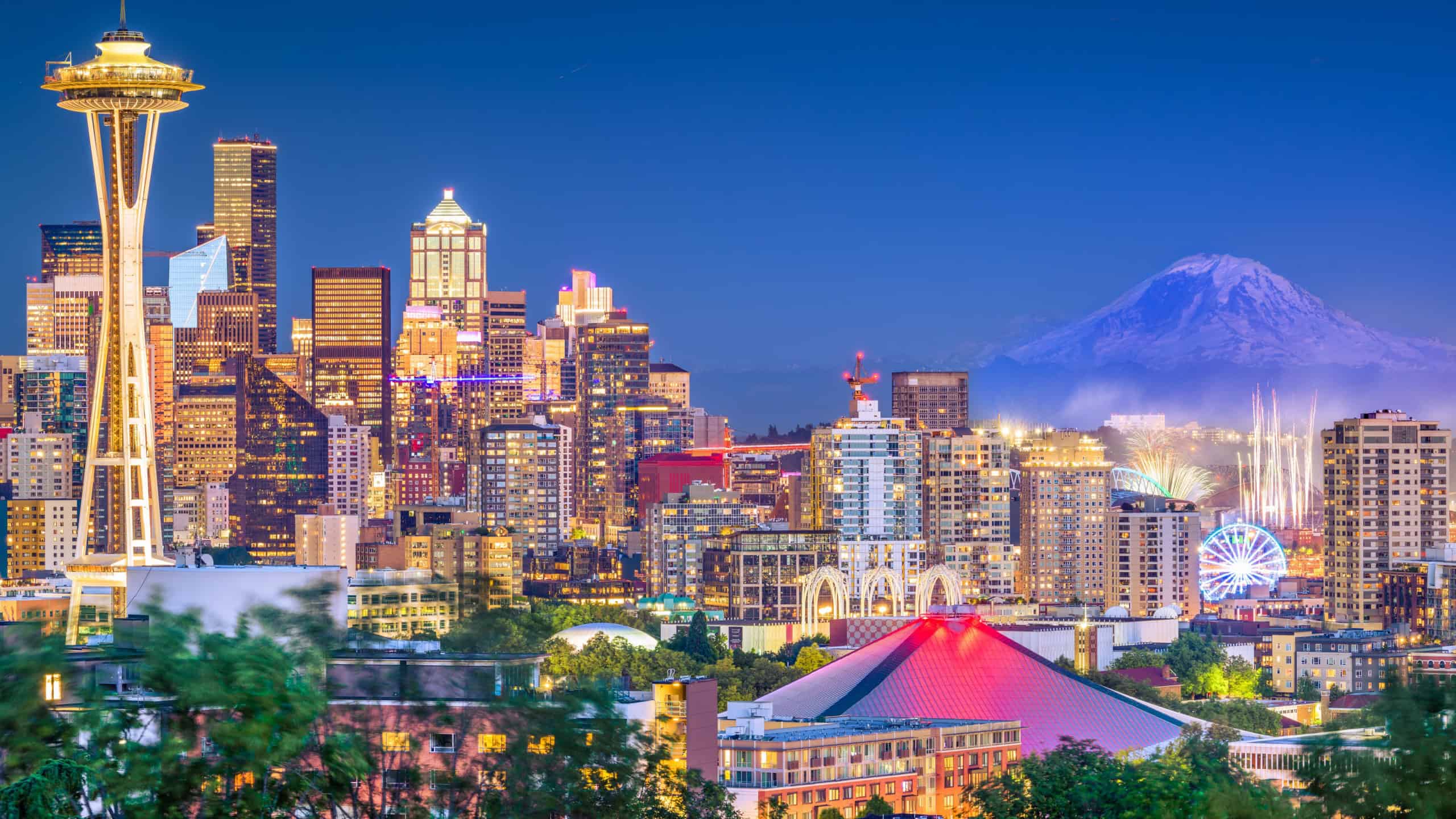 Seattle, Washington, USA downtown skyline at night with Mt. Rainier.