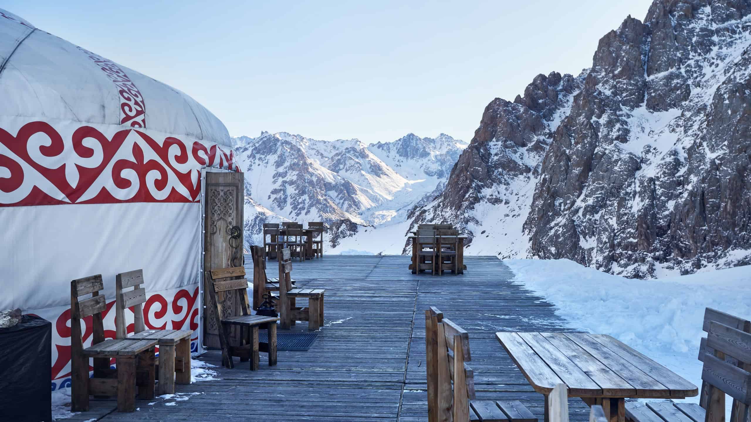 Hotel and Restaurant from Yurt nomadic house complex with table and chair at Ski resort Shymbulak in Almaty, Kazakhstan. Winter snowfall outdoor tourism concept.