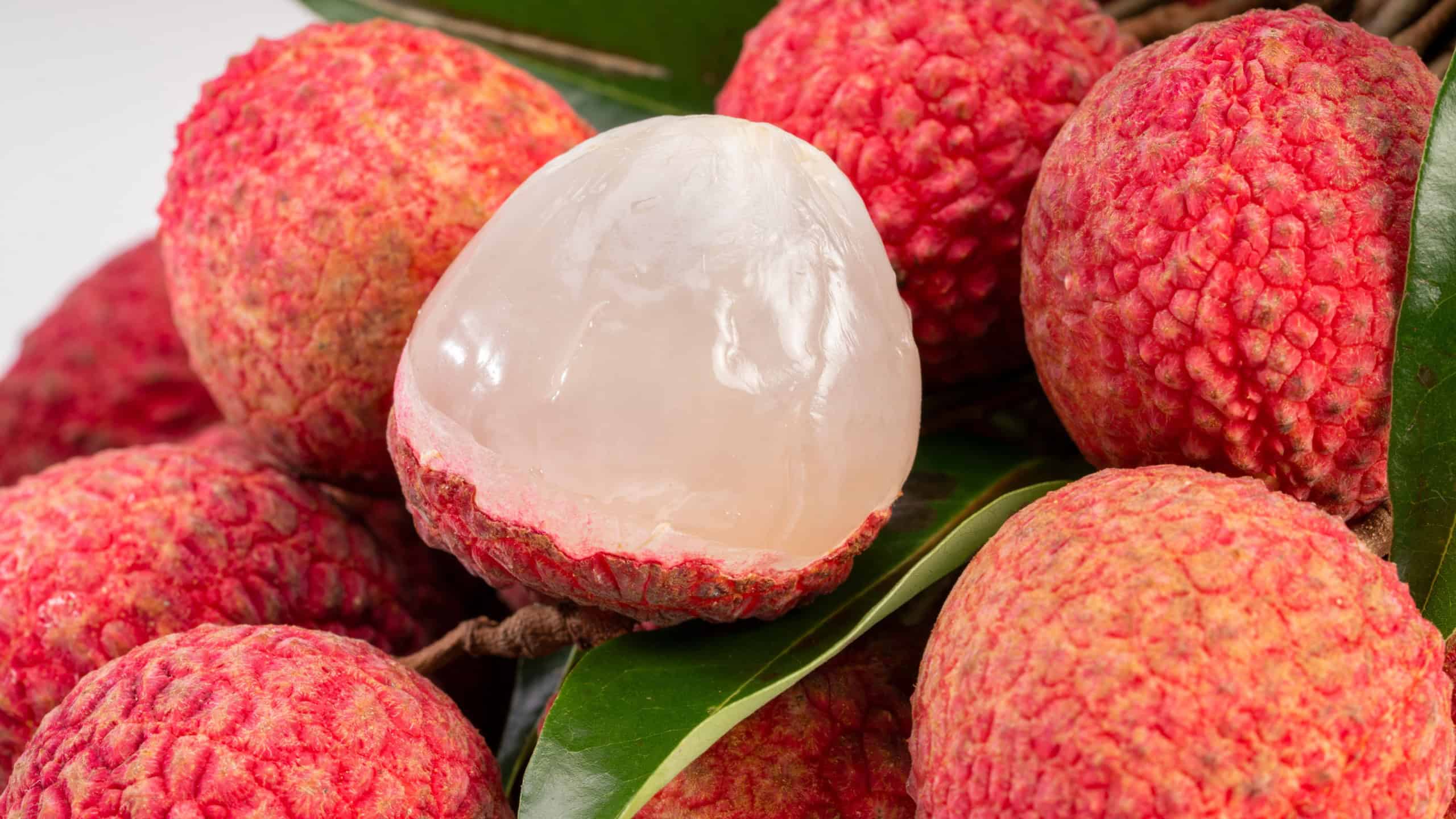 Fresh Lychee with leaves white background, Sweet lychees fruits with leaves on White