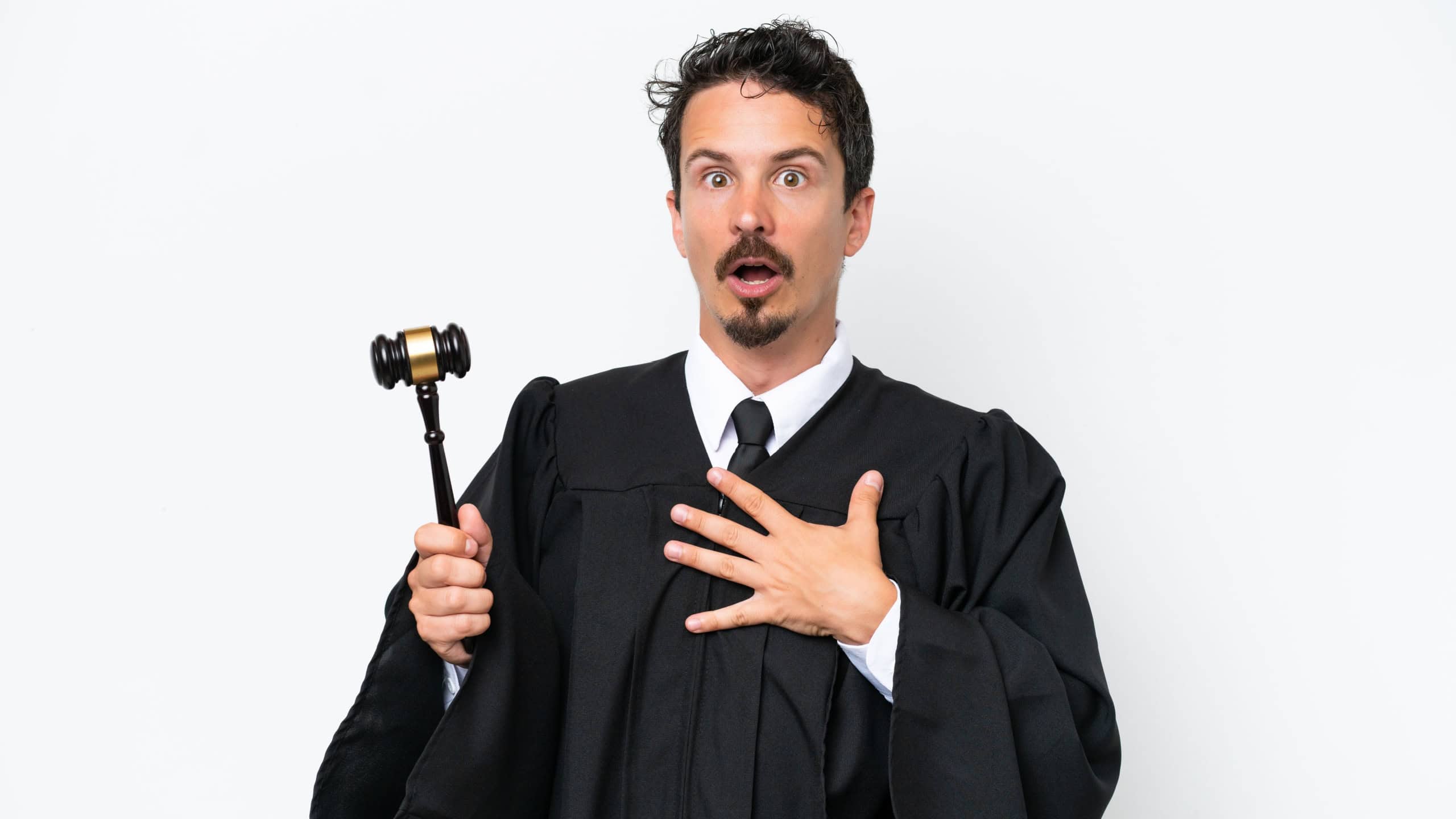 Young judge caucasian man isolated on white background surprised and shocked while looking right