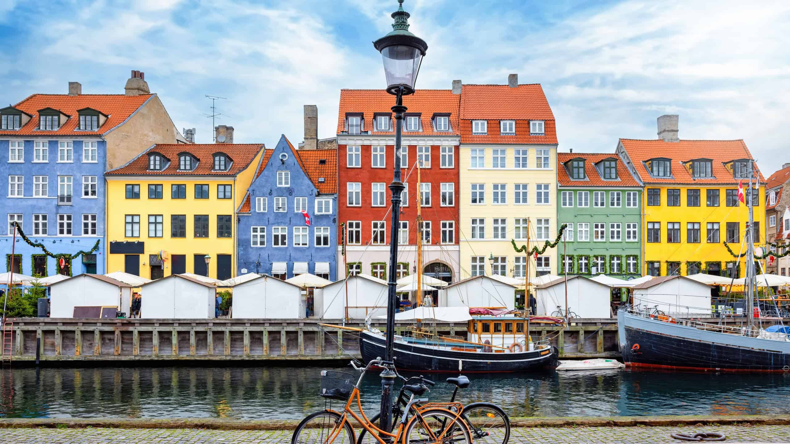 The popular Nyhavn area at Copenhagen, Denmark, with a street light and bicycles in front of the colorful houses