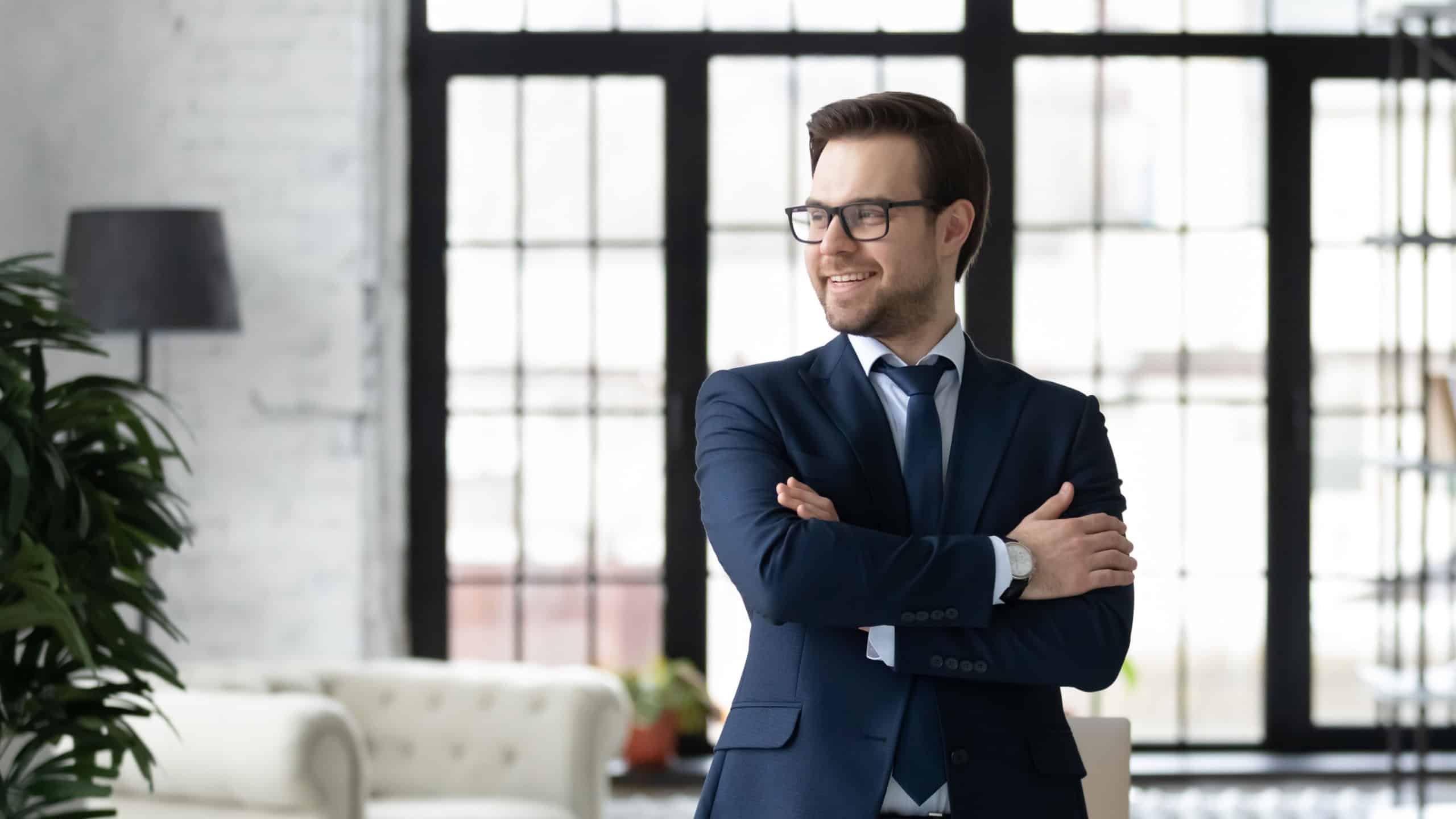 Happy confident business owner, CEO, company leader looking away, smiling, thinking of future profit and success. Head shot portrait of successful businessman in glasses in office. Leadership concept