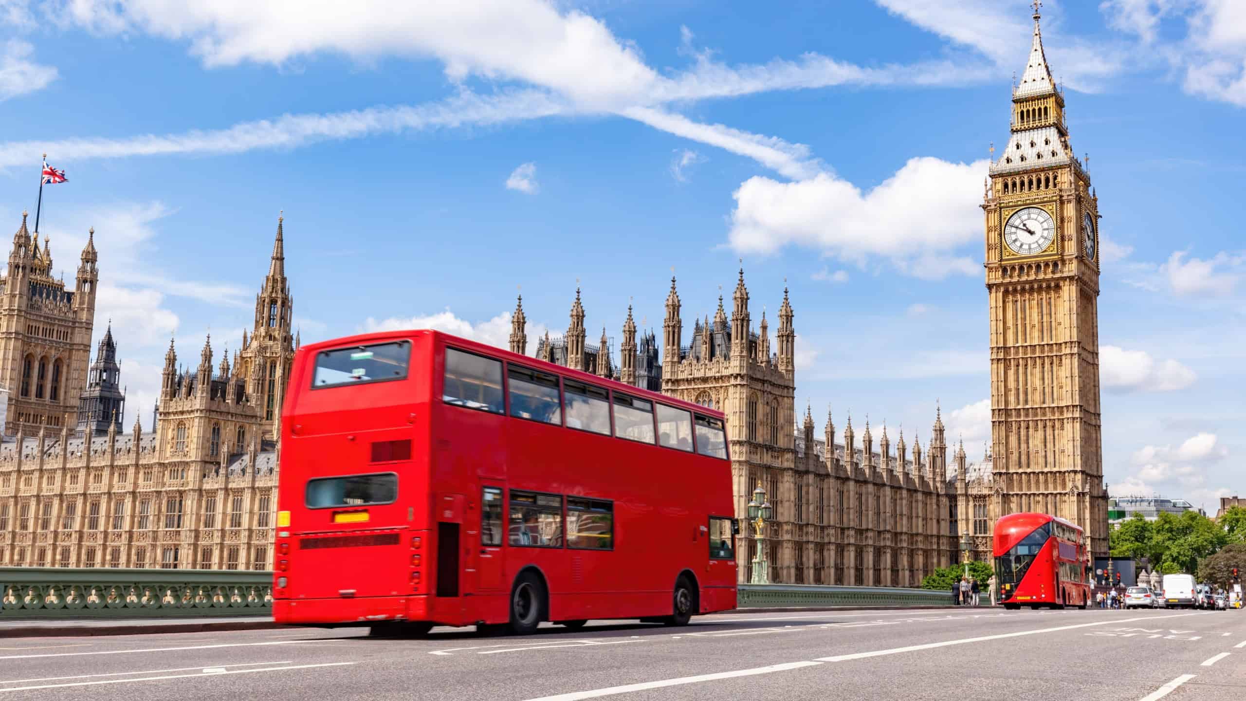 Red bus on Westminster bridge next to Big Ben in London, the UK. Tourist landmark