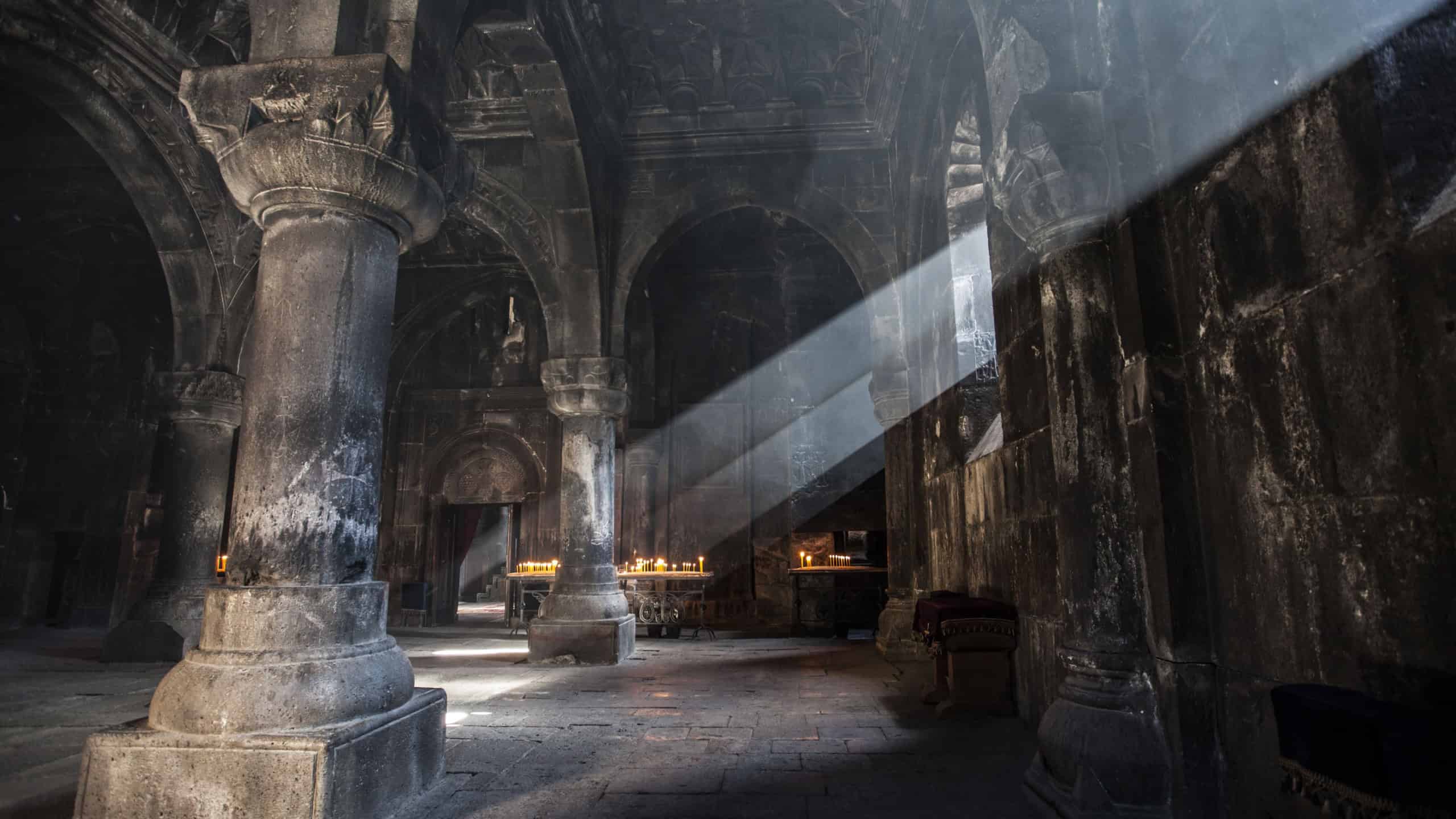 Old ancient Armenian christian church interior with amazing natural light. Geghard Monastery, 12 century
