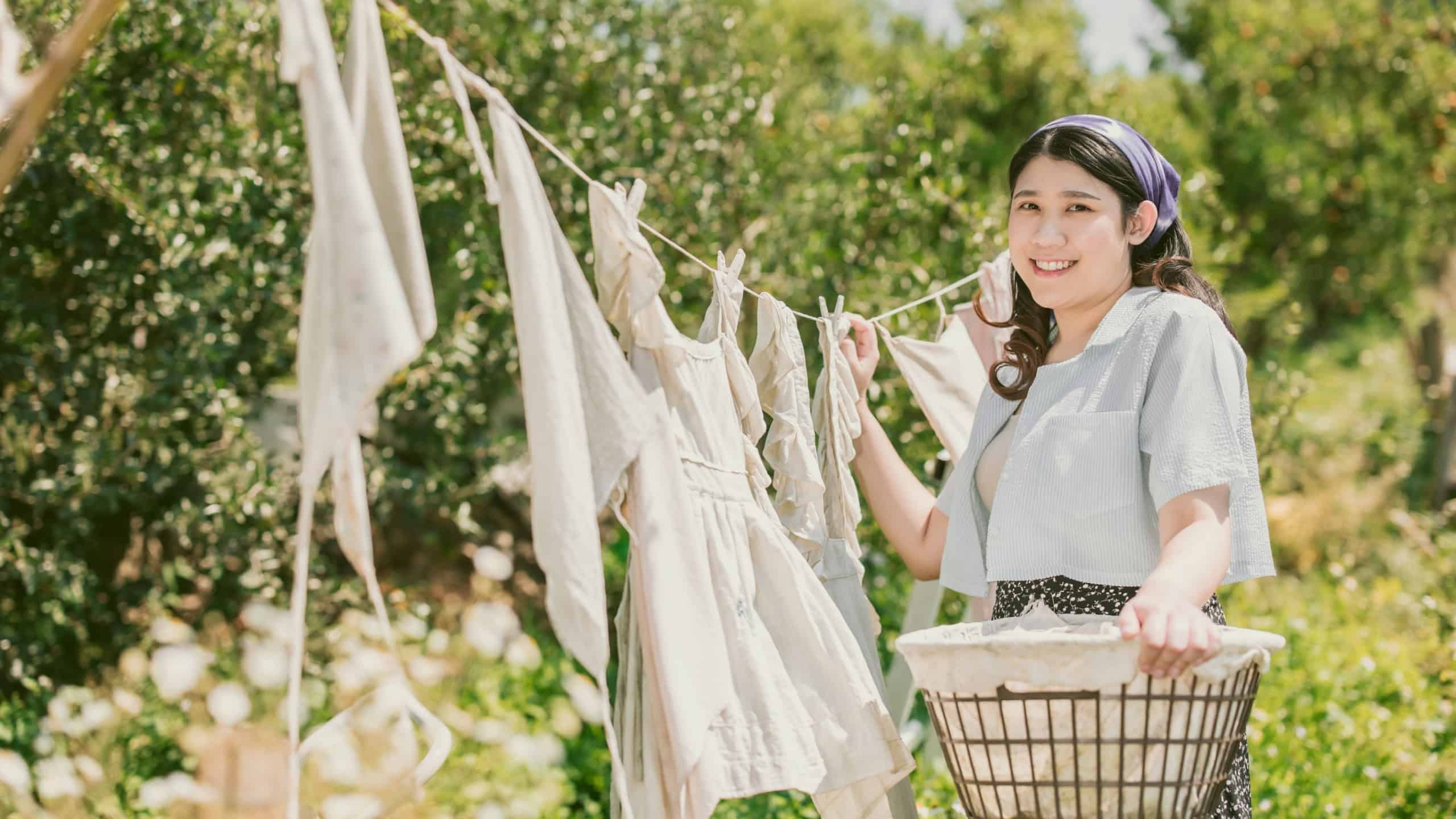 Rural farm girl folk women maid housewife drying clothes outdoors vintage retro style countryside people.