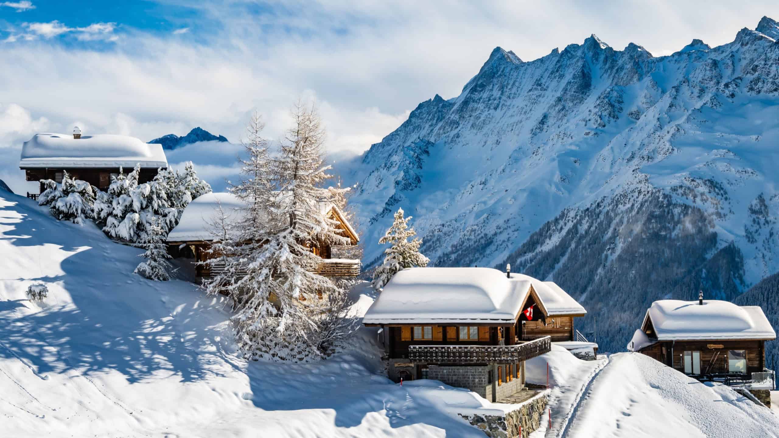 Traditional alpine wooden houses in winter mountain snow landscape, Loetschental valley, Switzerland