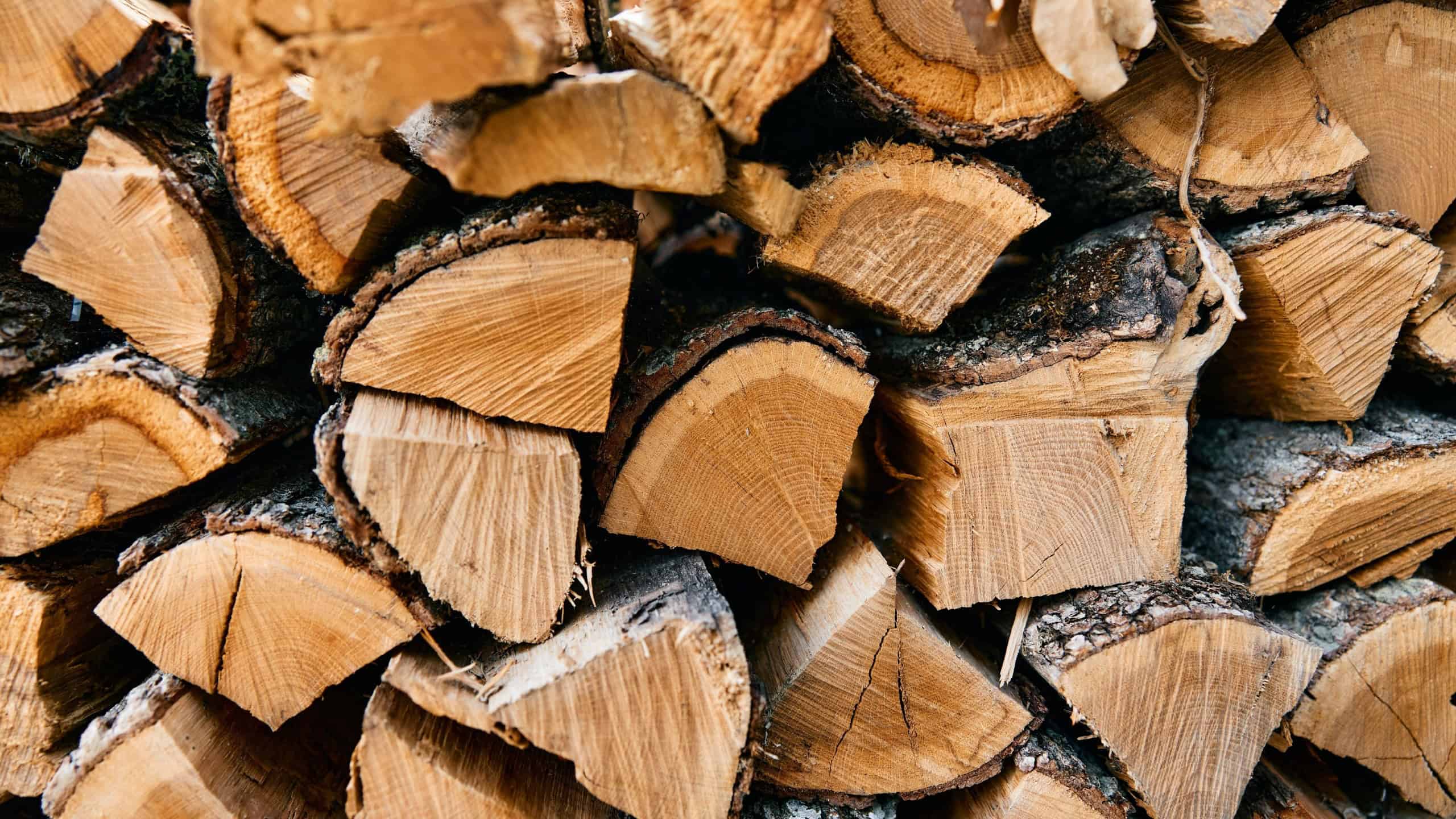 Rustic firewood pile in a cozy outdoor setting, perfect for a winter evening by the fire
