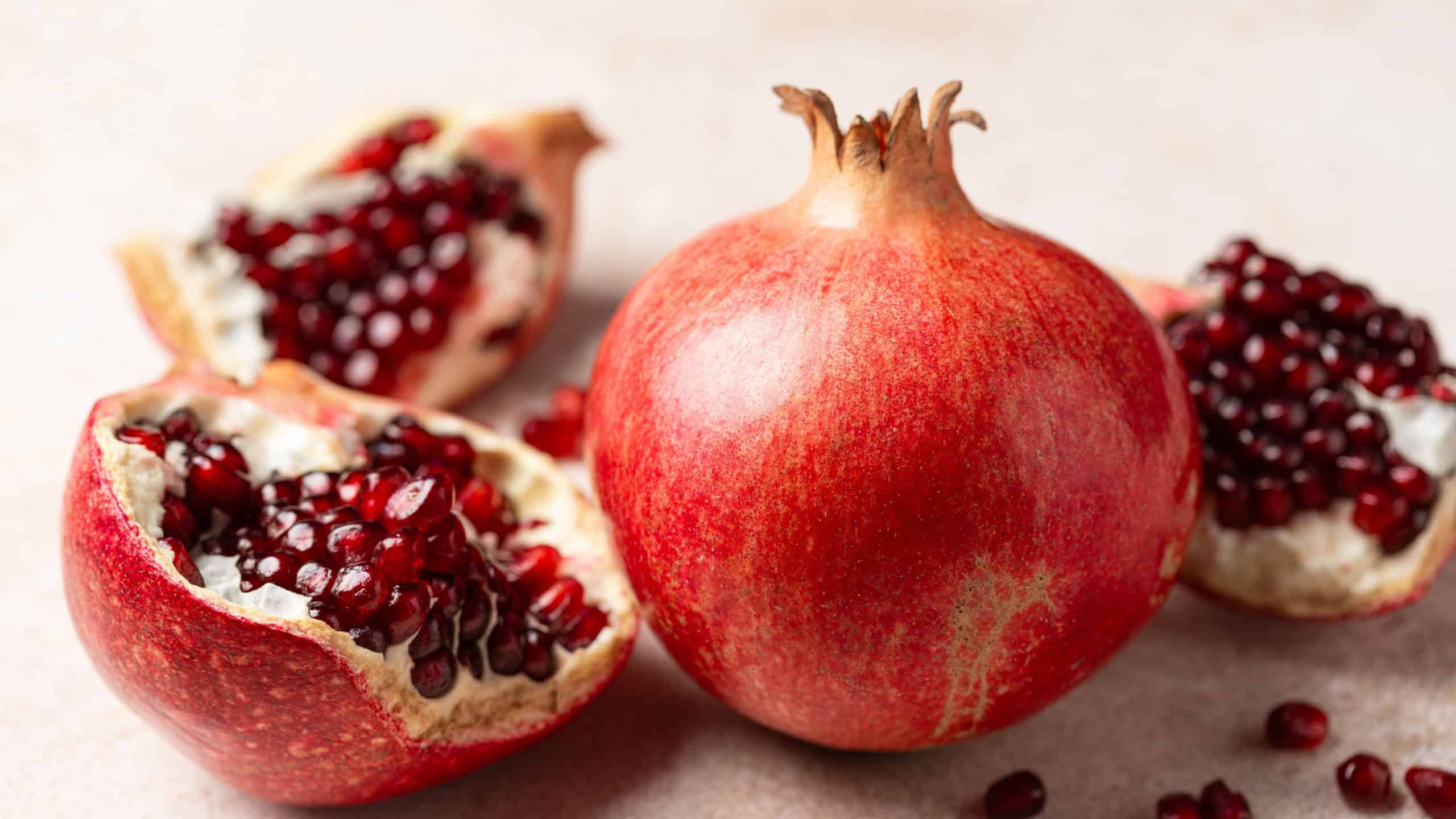Pomegranate. Fresh organic juicy pomegranate fruit pieces. Pomegranate seeds, grains.