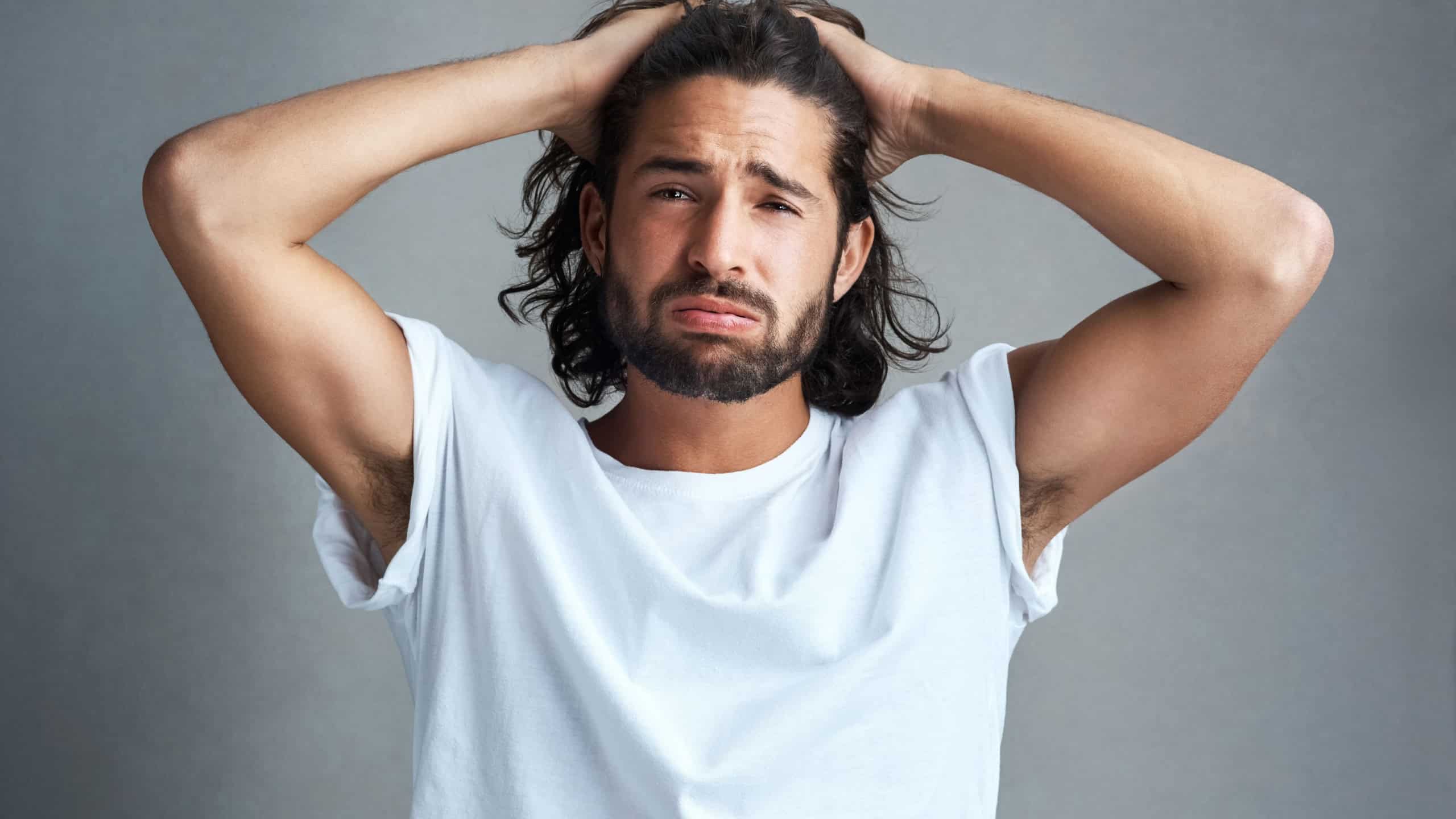 Stress, frustrated and portrait of man in studio with mental health, regret and thinking of mistake. Anxiety, anger and confused male person with depression, failure or burnout on grey background