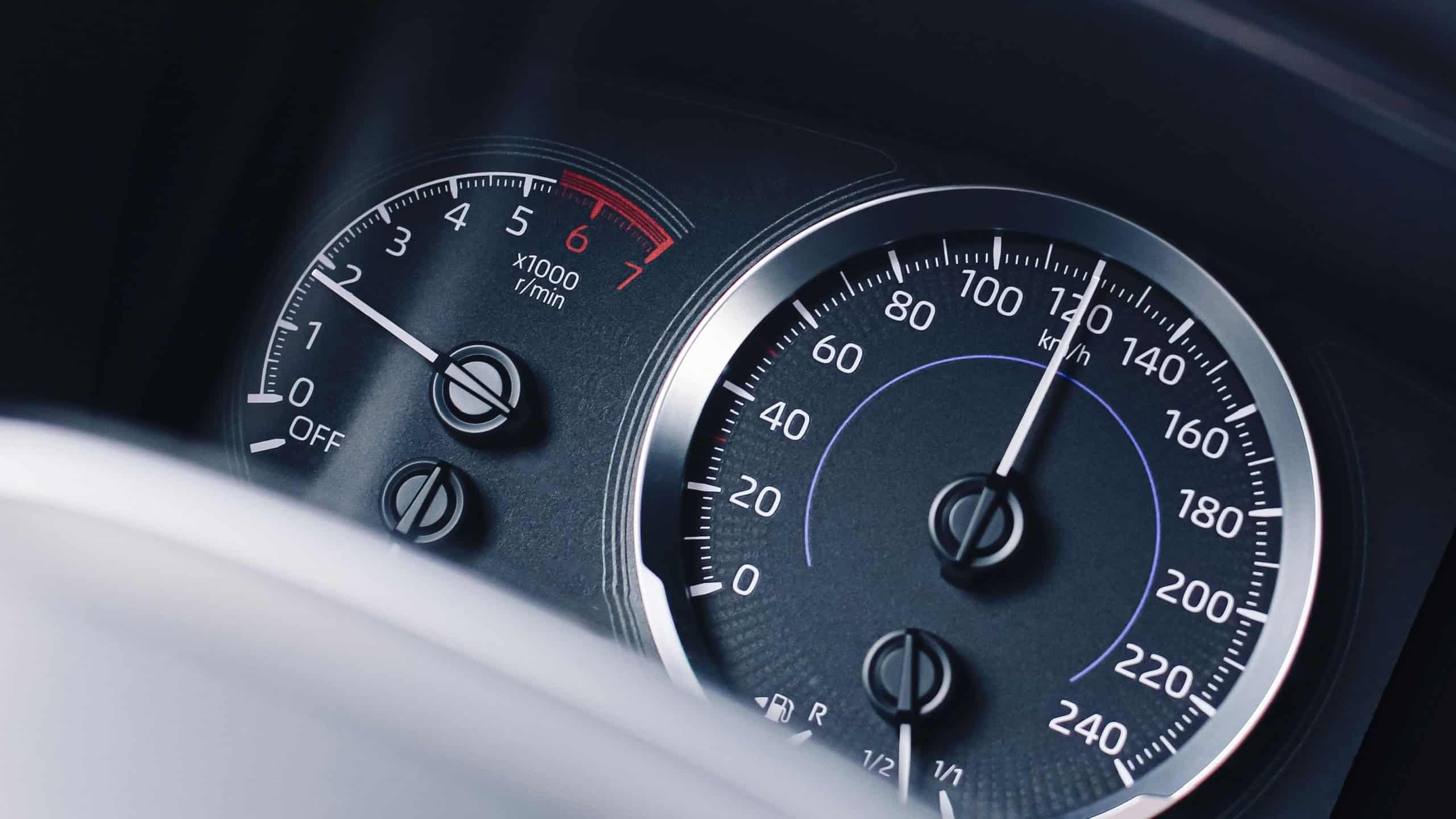 Car speed dashboard closeup. Speedometer and tachometer. Fast driving concept. Auto instrument panel. Modern vehicle detail. Travel and transport. Drive fast. Sport car style. Car interior background.