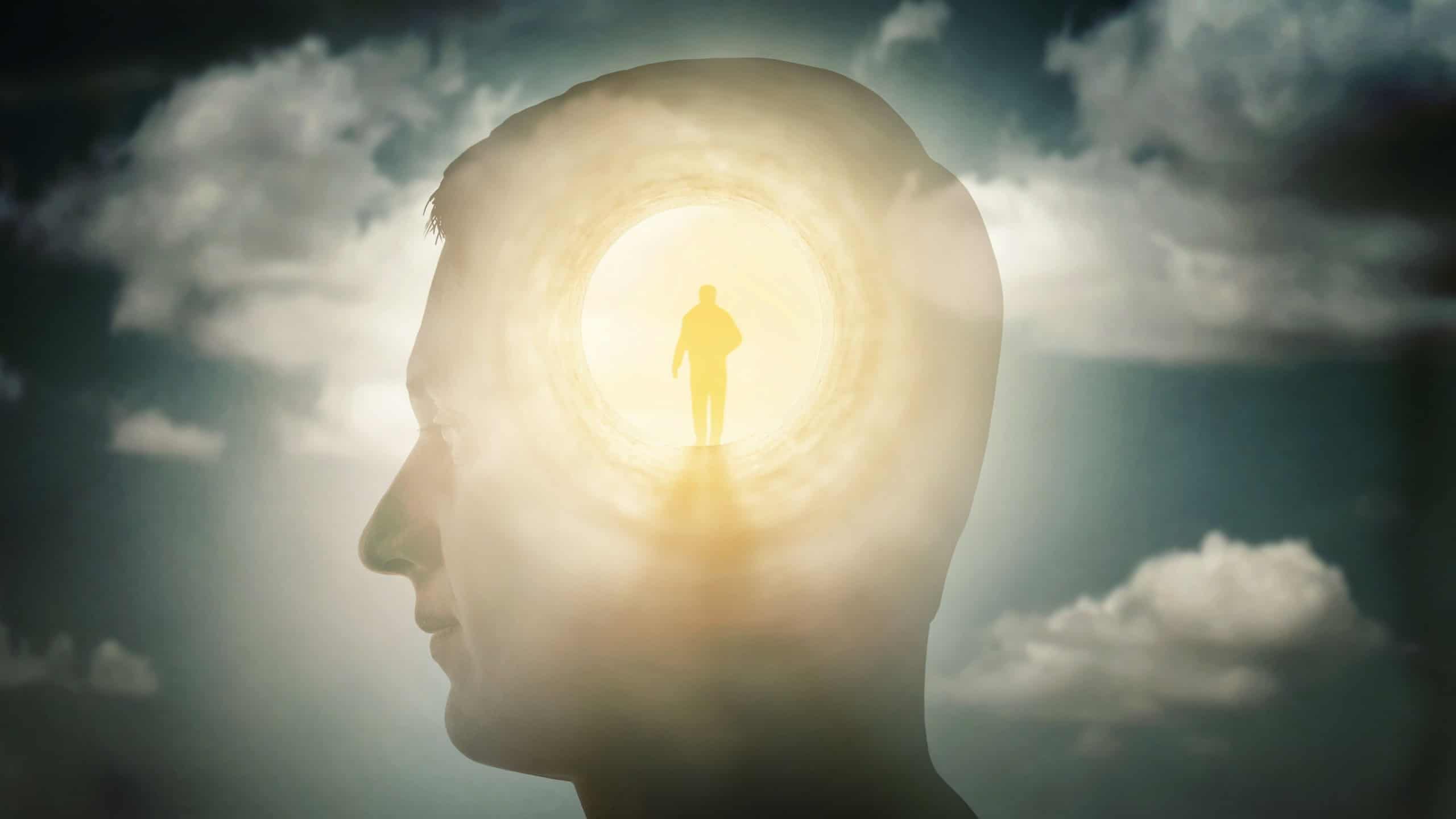 A silhouete of a man with rays of light emanating from the brain as a symbol of the power of thinking. Concept on the topic of psychiatry, psychology, religion, science, spiritual growth.