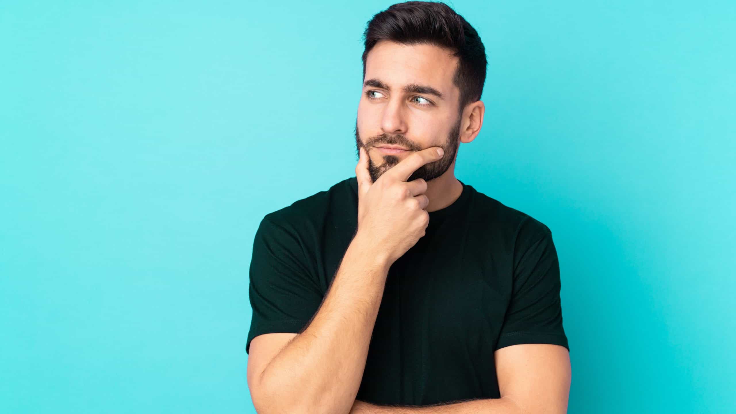 Caucasian handsome man isolated on blue background having doubts and with confuse face expression