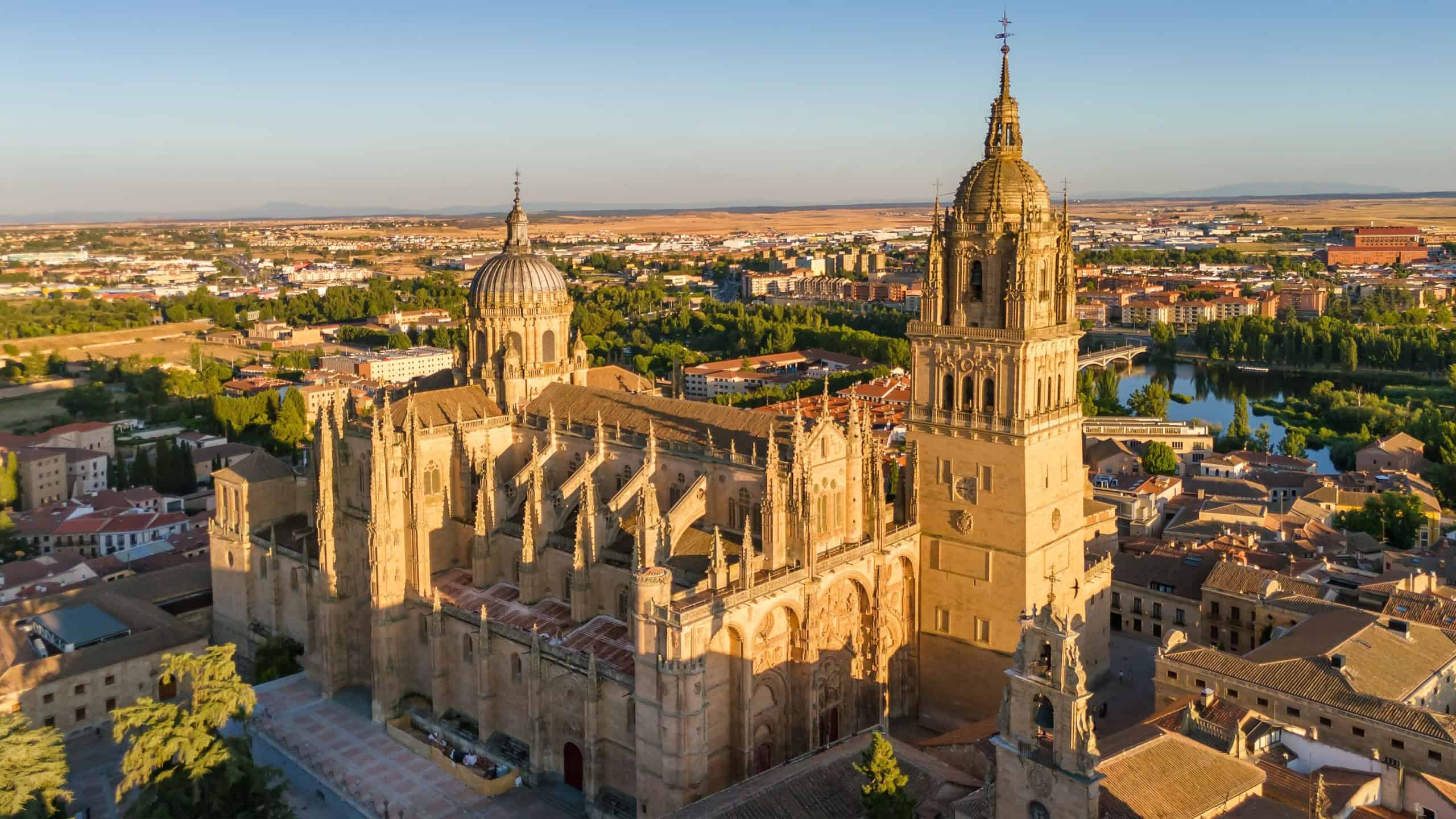 Aerial view of the historic cityscape of Salamanca at sunset, Castilla y Leon, Spain. Medieval city with Salamanca Cathedral, Torre del Clavero, and the historic University. UNESCO World Heritage Site