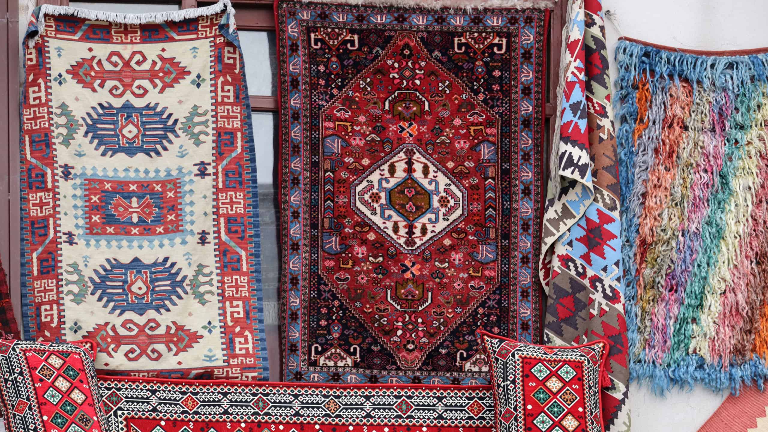 Colorful, authentic handwoven Turkish carpets with geometric patterns.