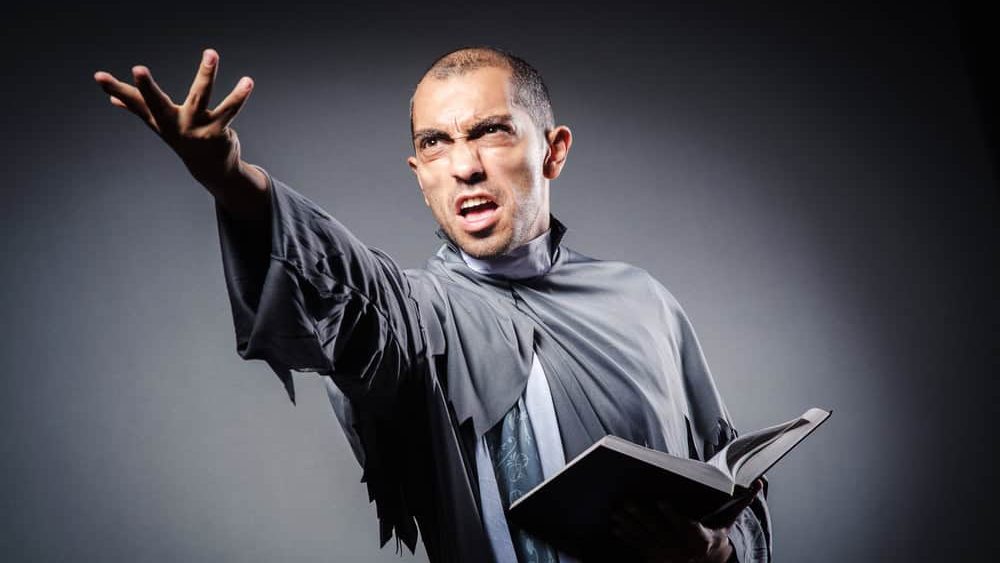 Young priest isolated on the white