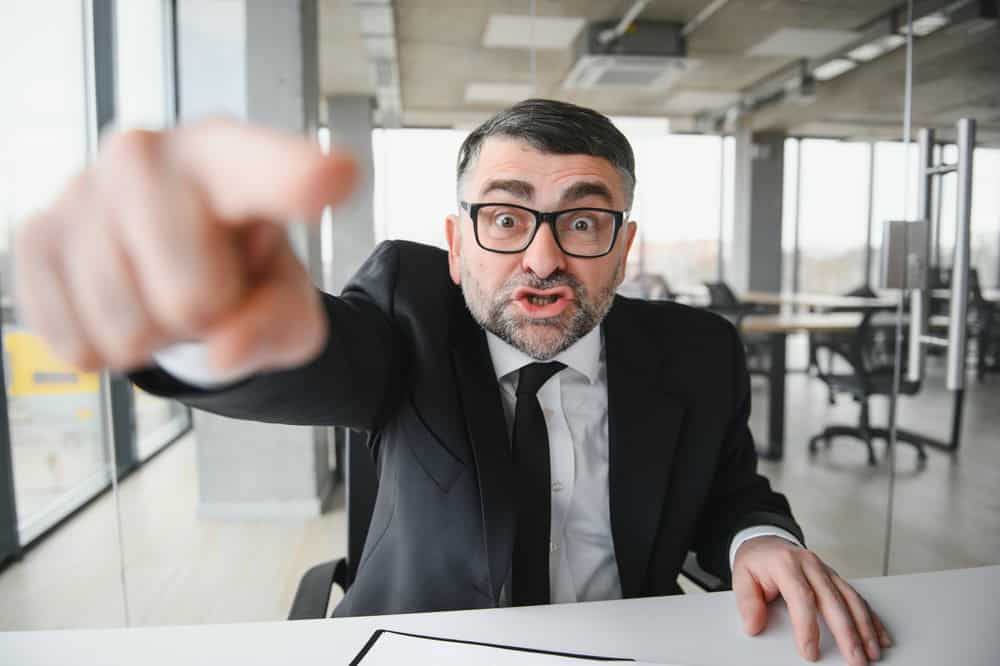 Angry boss shouting at his employee.