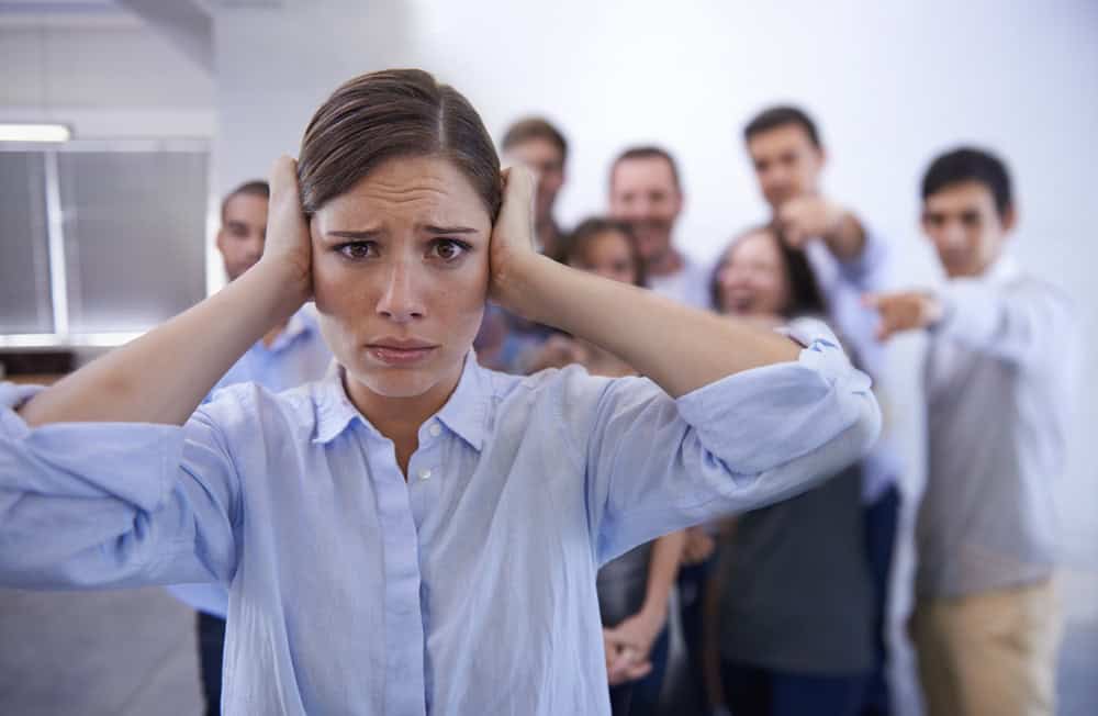 Business, bullying and portrait of woman with stress in office with harassment, prank or hand pointing mock. Judgment, joke and face of worker with new job judgment, shame or corporate gossip victim
