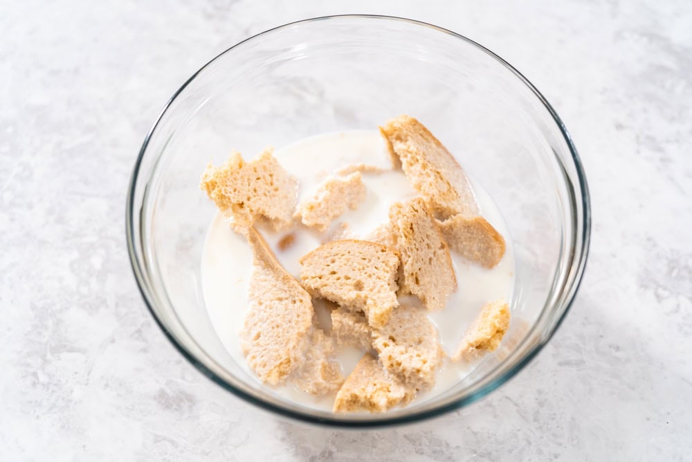 Soaking stale bread in milk to make meatloaf.