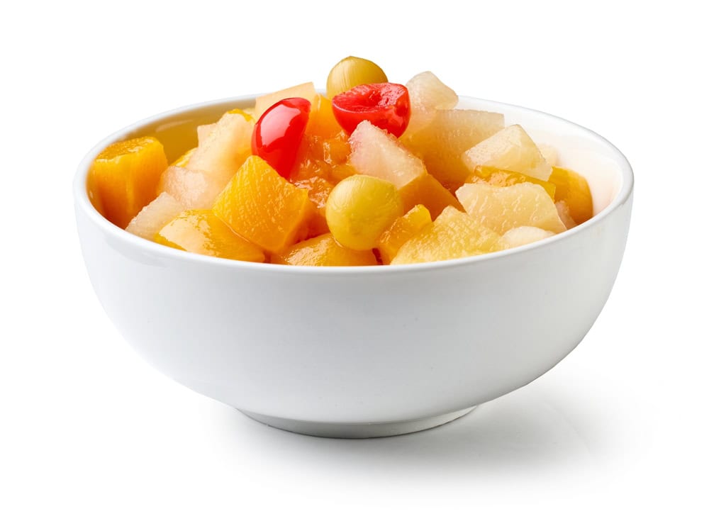 Bowl of canned fruit salad cocktail isolated on white background